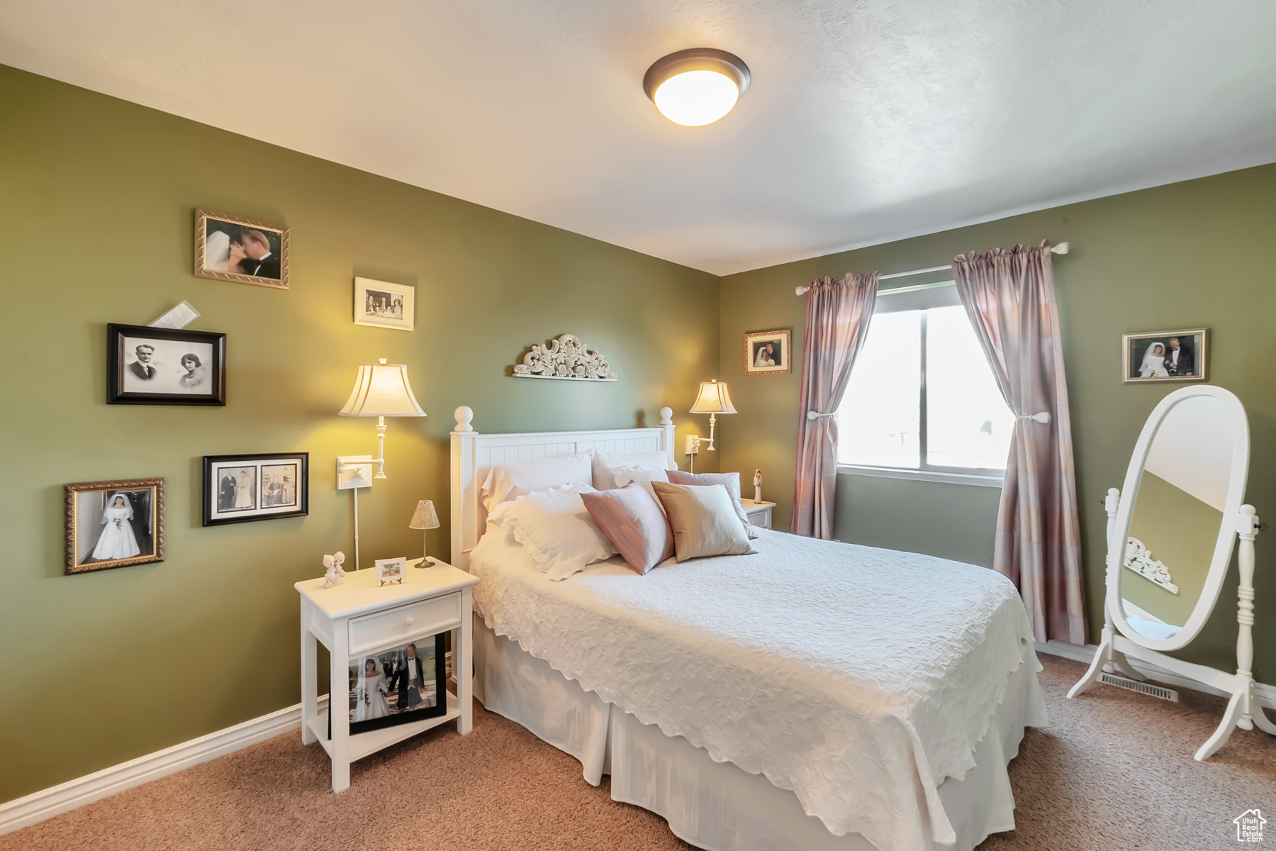 Bedroom with light carpet and baseboards