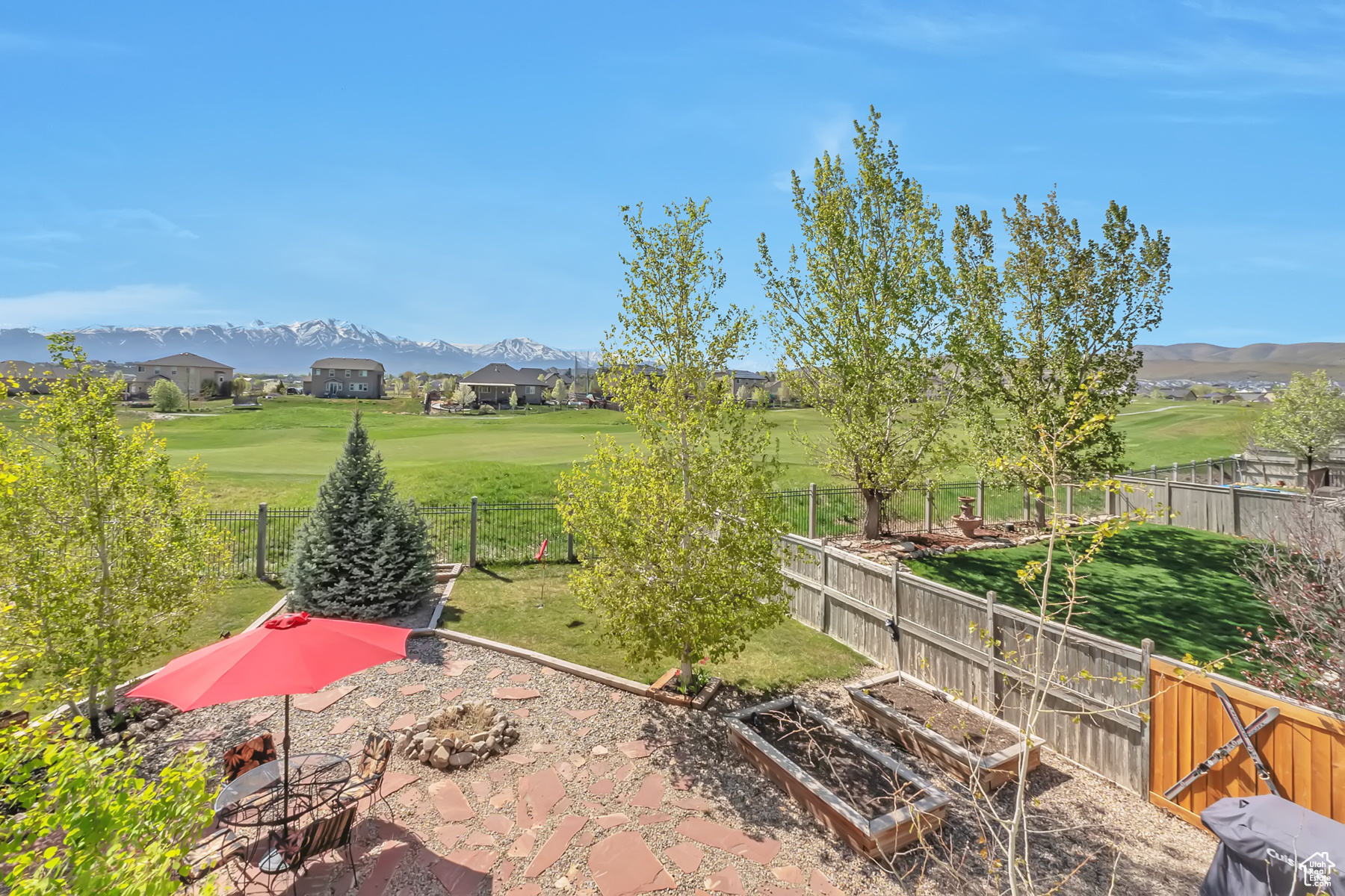 View of yard with a vegetable garden, a fenced backyard, and a mountain view