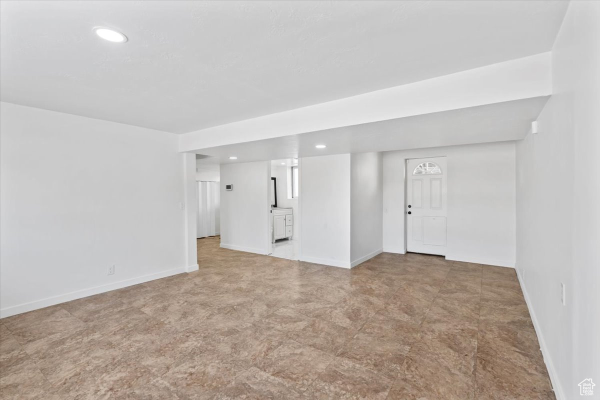 Empty room featuring baseboards and recessed lighting