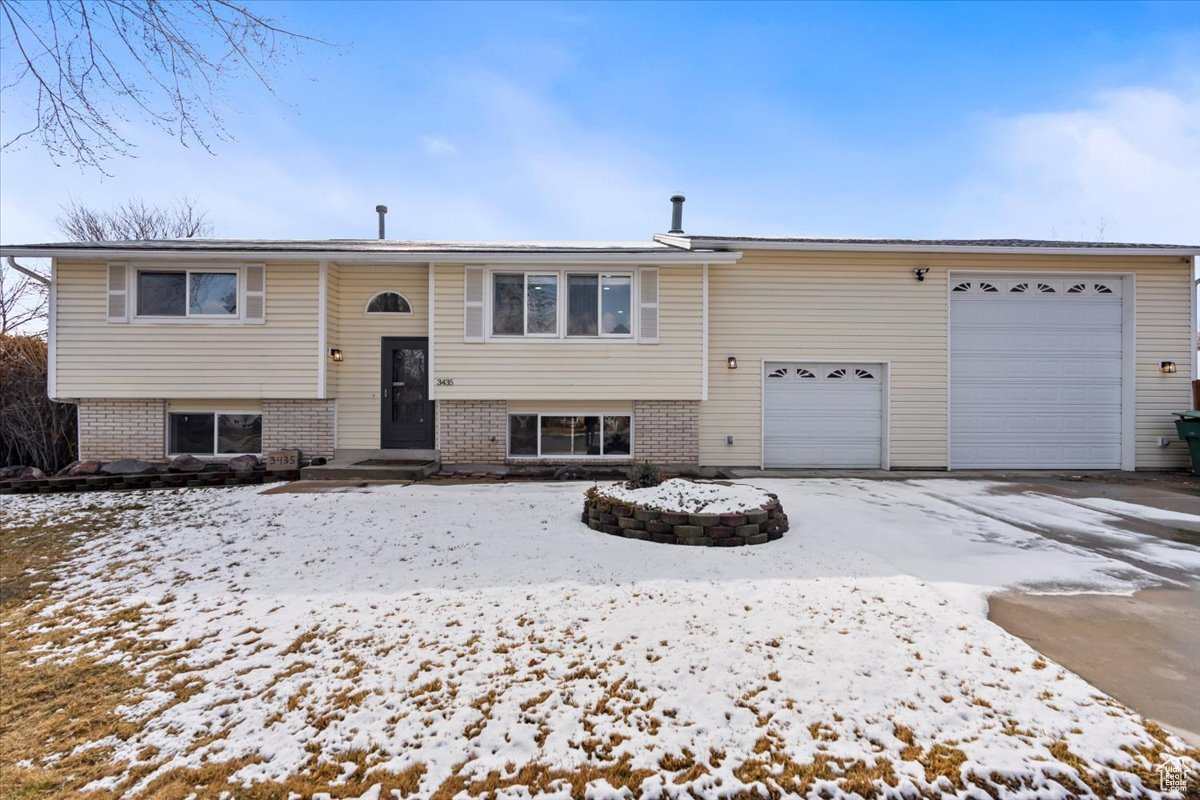 Split foyer home with a garage and brick siding