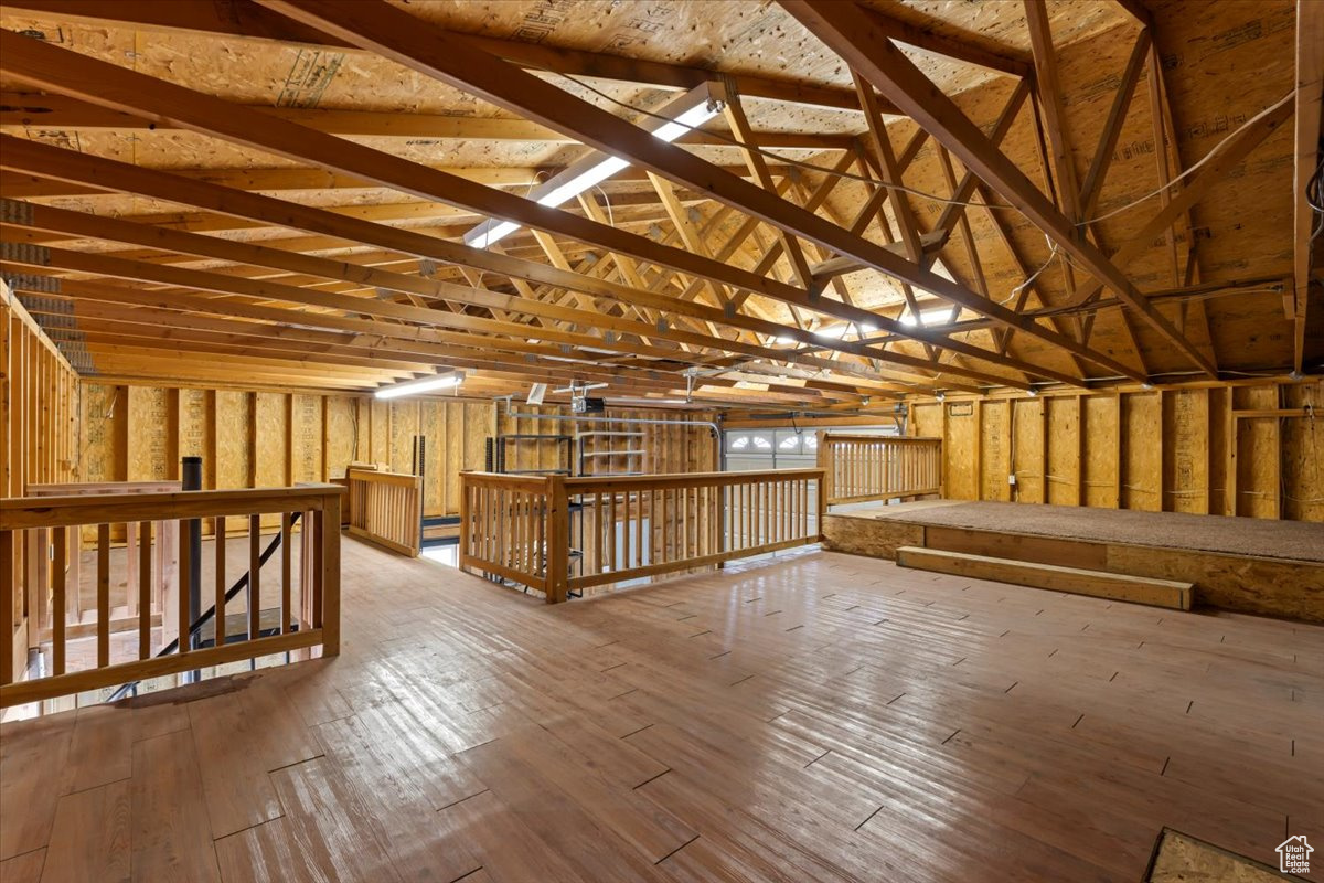 Interior space featuring vaulted ceiling and wood-type flooring