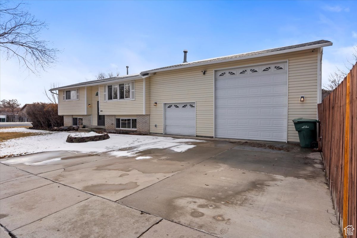 View of front of house featuring brick siding and fence