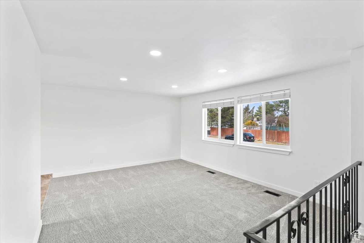 Unfurnished room with carpet, visible vents, baseboards, and recessed lighting