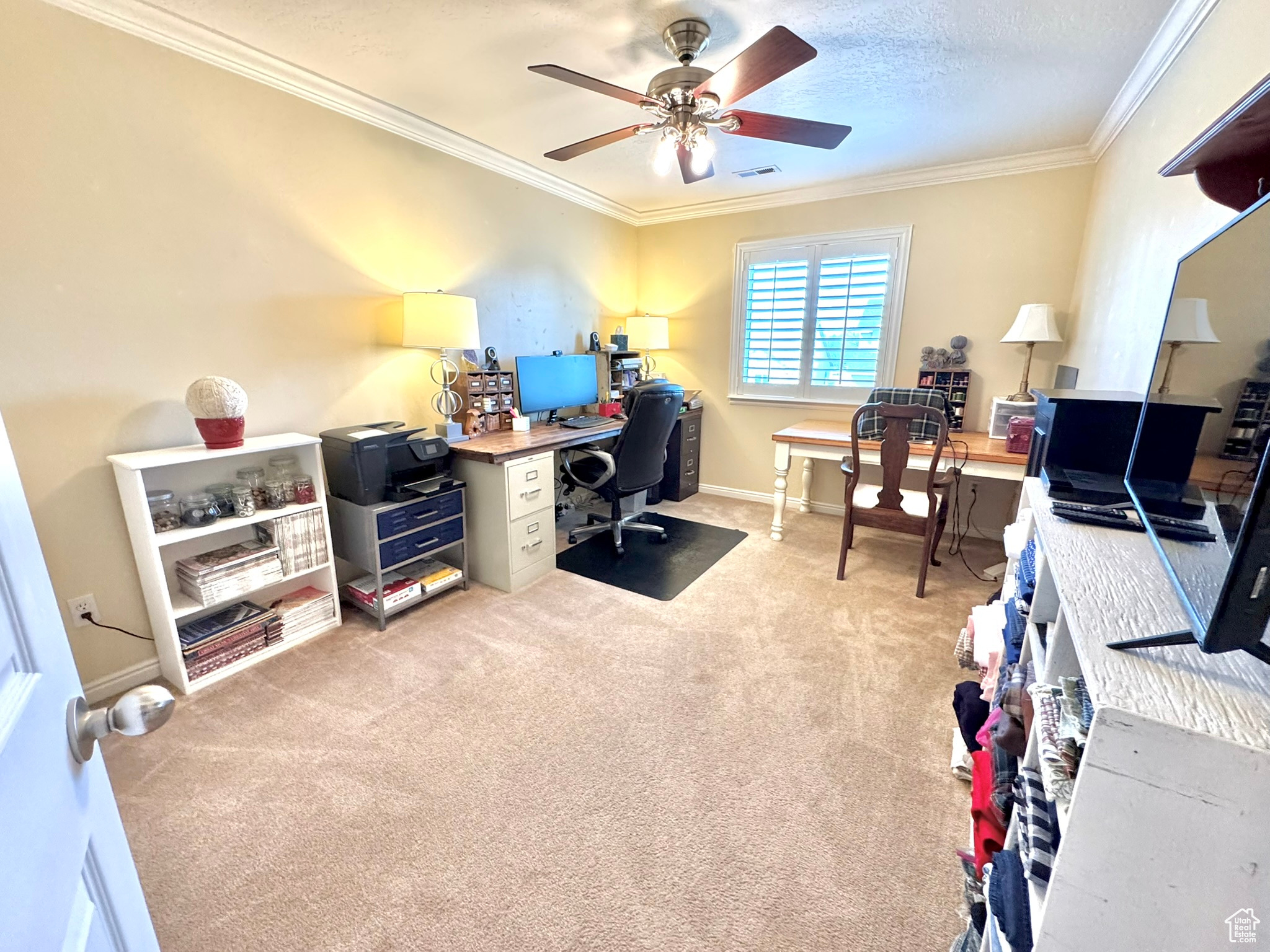 Bedroom 2 with light carpet, baseboards, ceiling fan, a textured ceiling, and crown molding