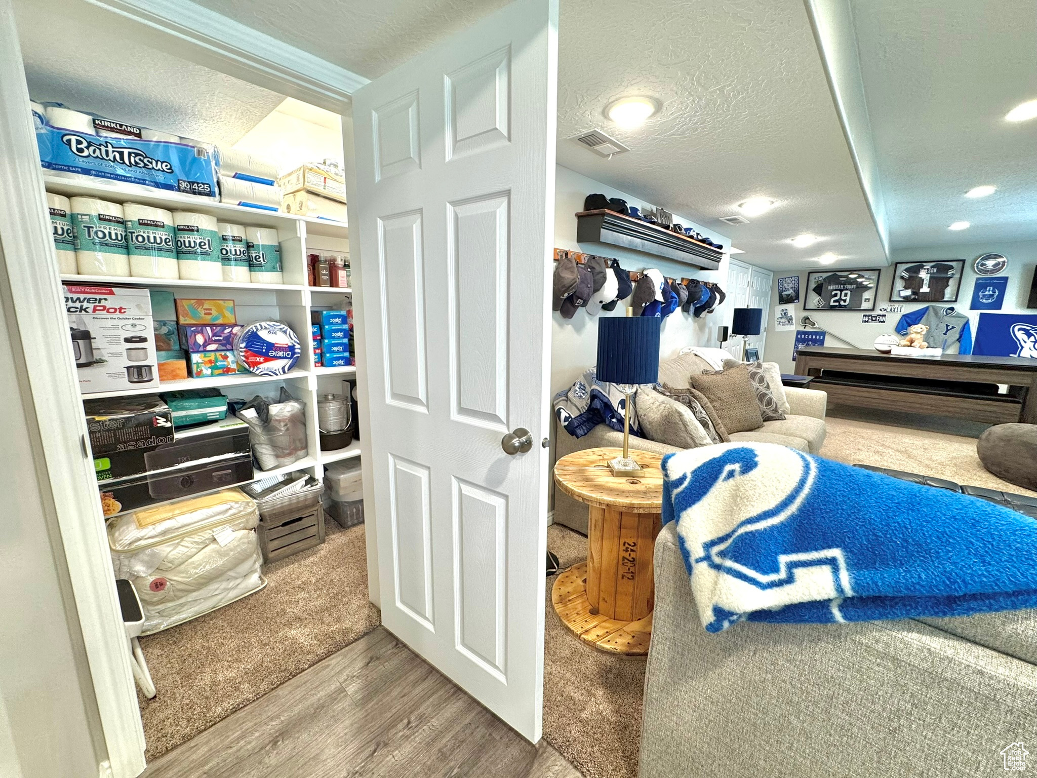 storage under the stairs in kitchenette.