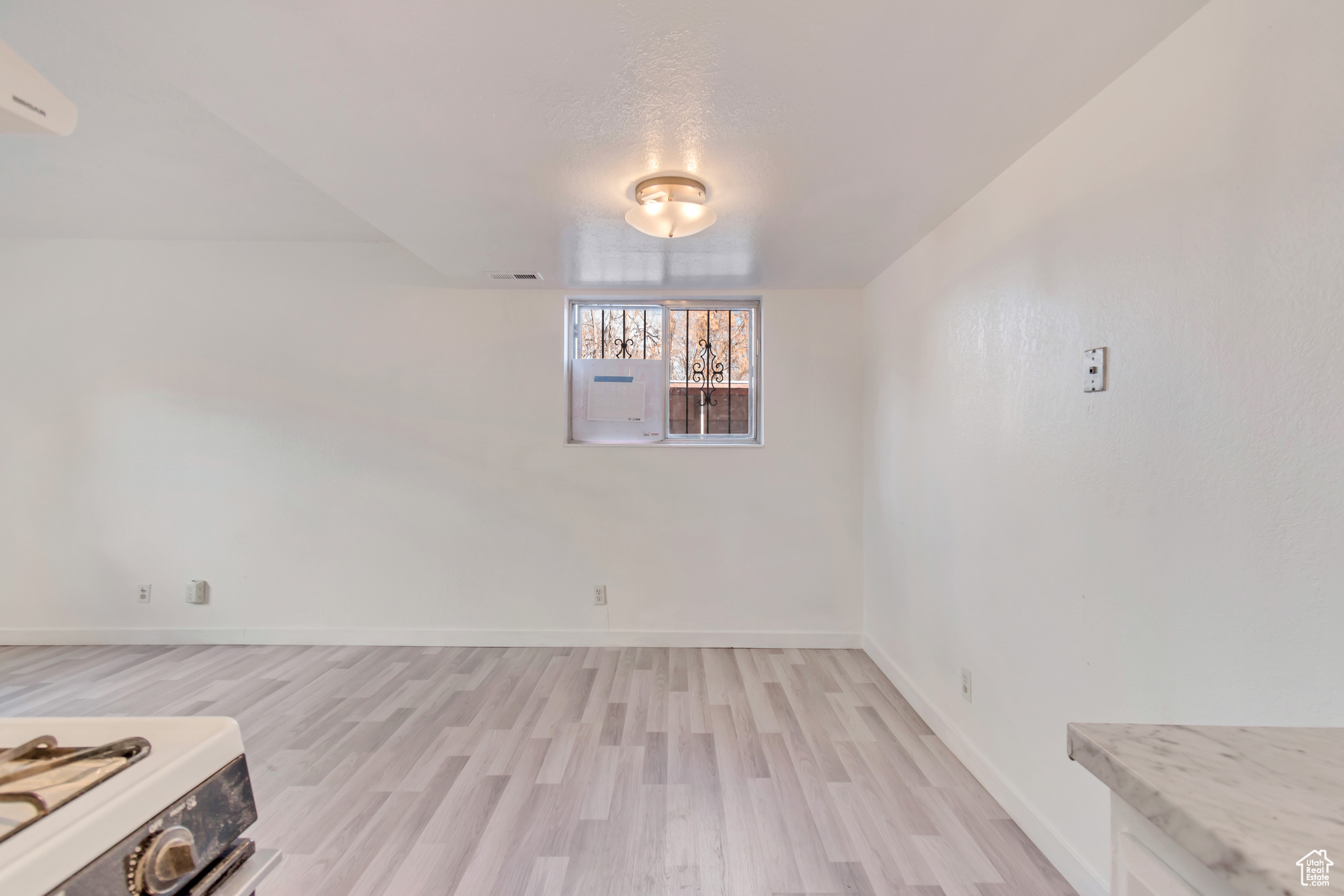 Unfurnished dining area featuring light wood finished floors, visible vents, and baseboards