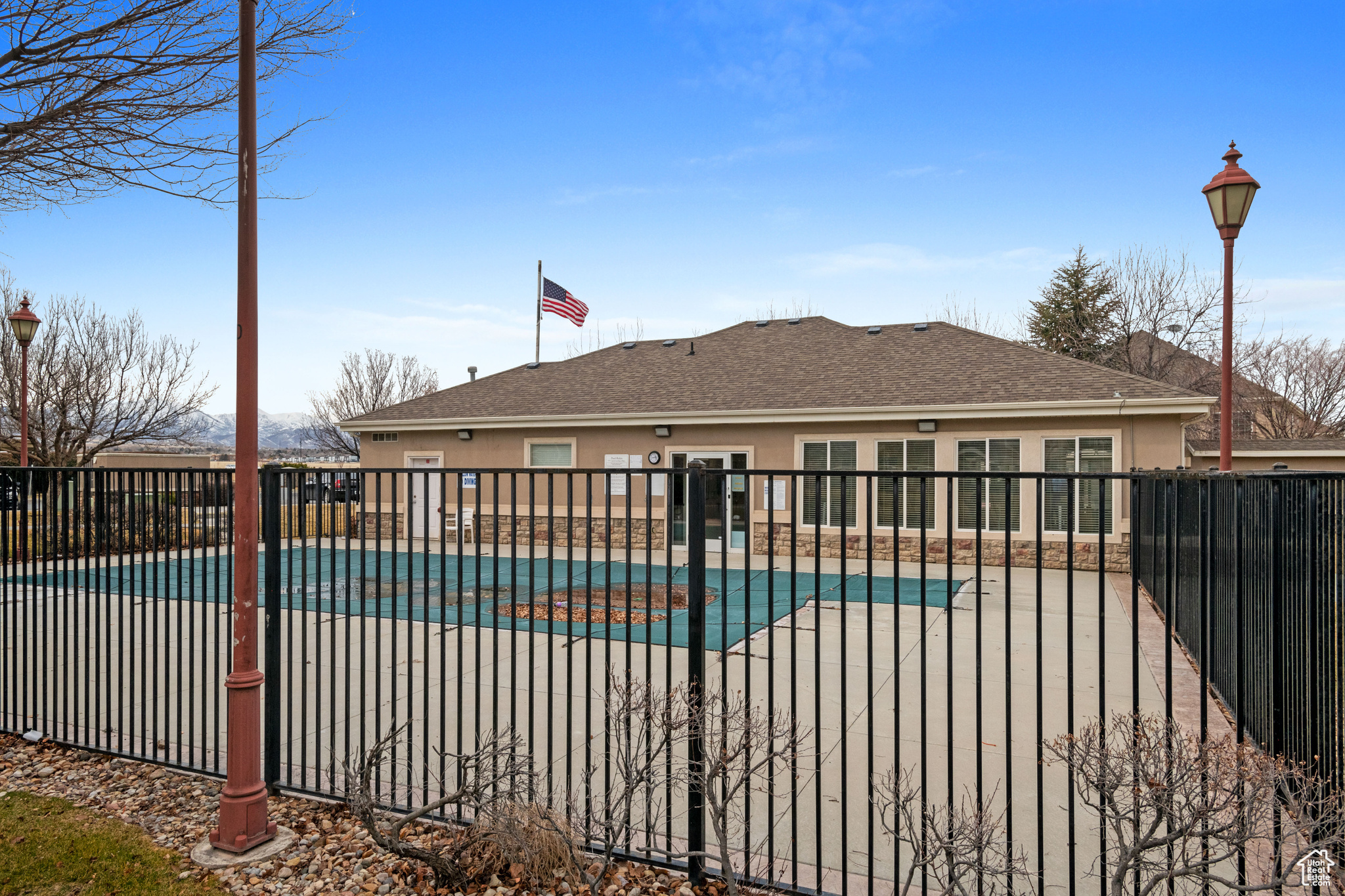 Community pool featuring a patio area and fence