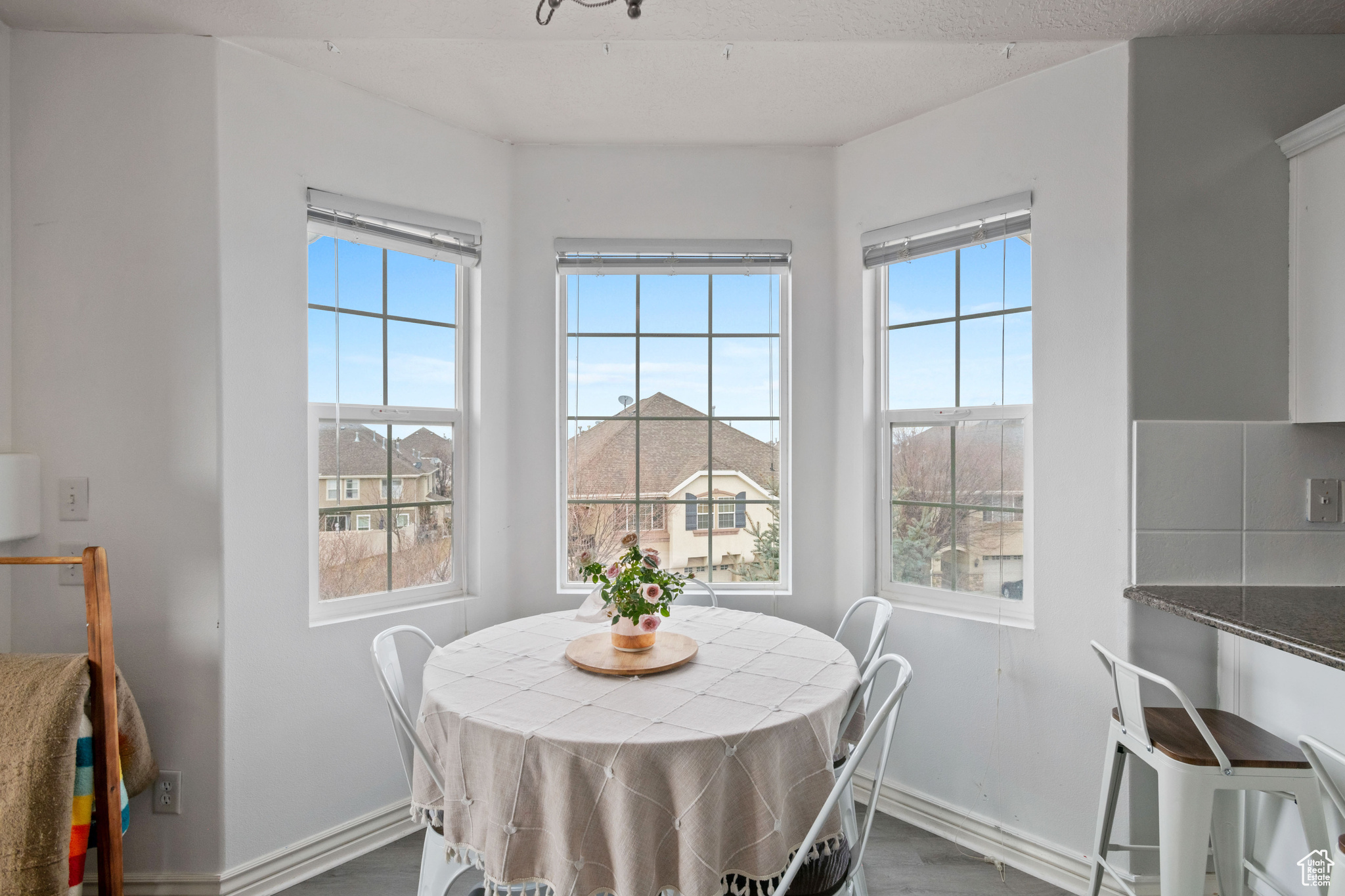 Dining space with dark wood finished floors and baseboards