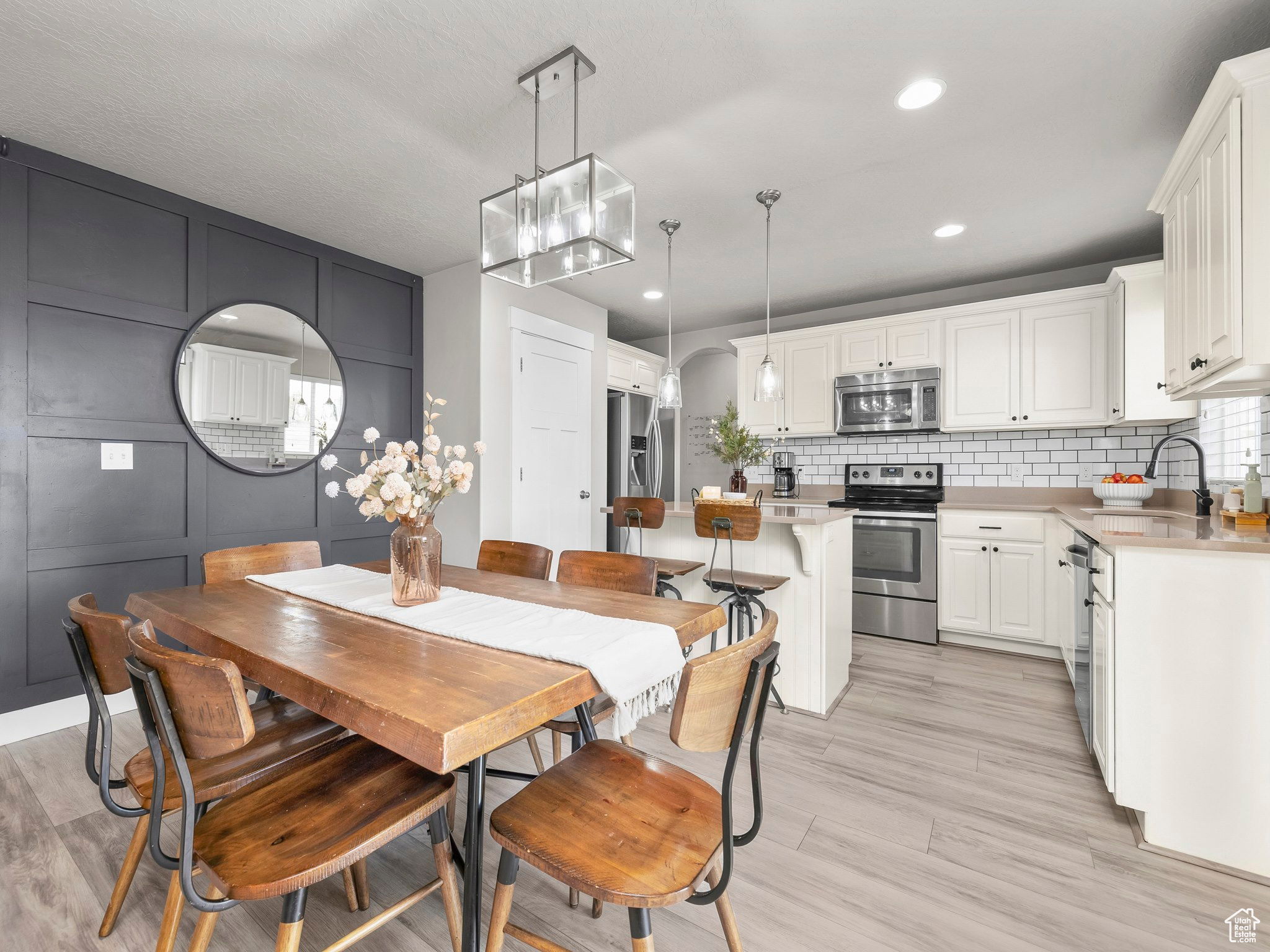 Dining space featuring light wood finished floors and recessed lighting