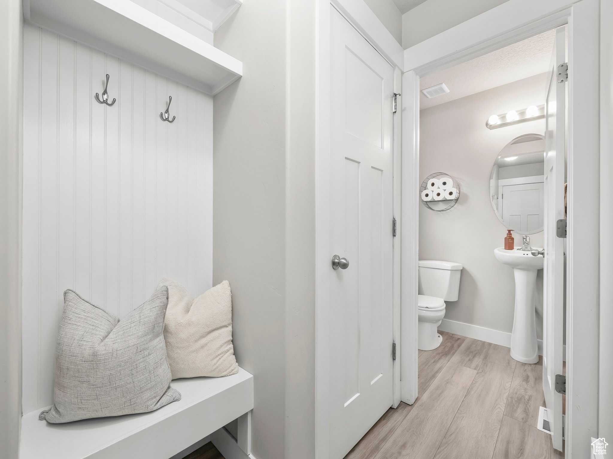 Mudroom featuring light wood-type flooring, visible vents, and baseboards