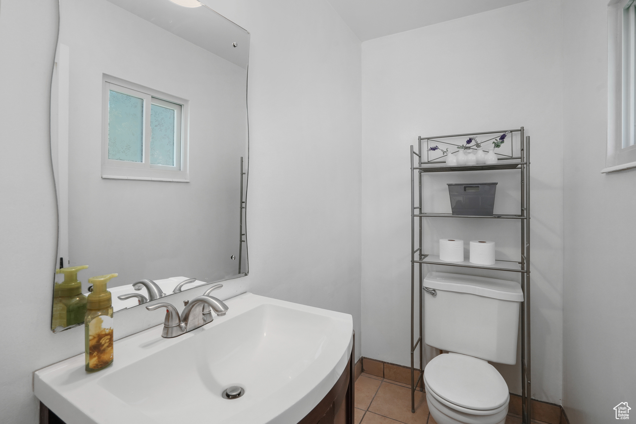 Bathroom with vanity, tile patterned flooring, and toilet