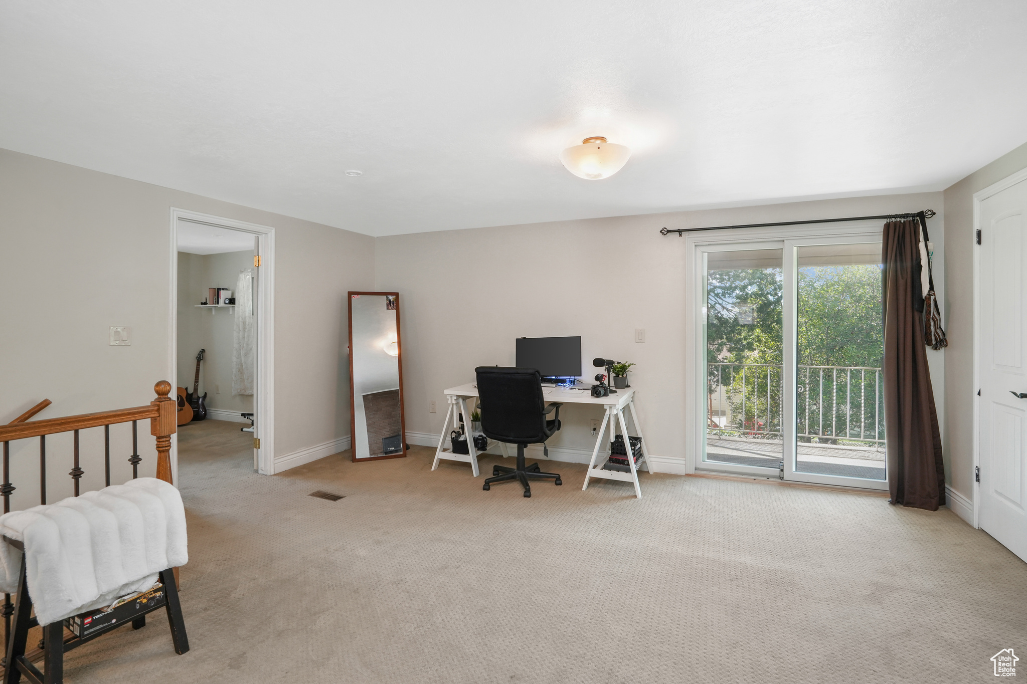Office area featuring baseboards and light colored carpet