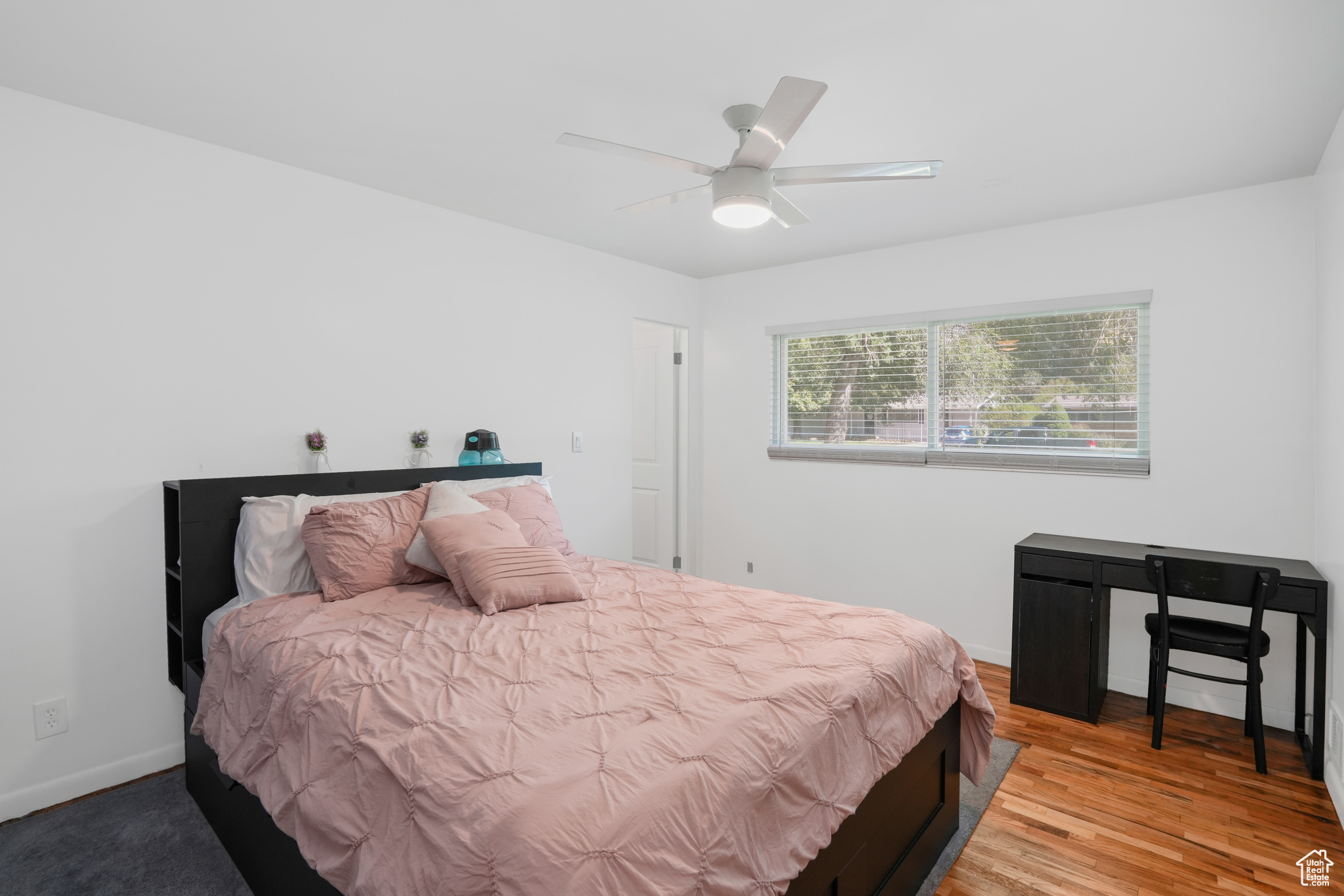 Bedroom with baseboards, a ceiling fan, and light wood-style floors