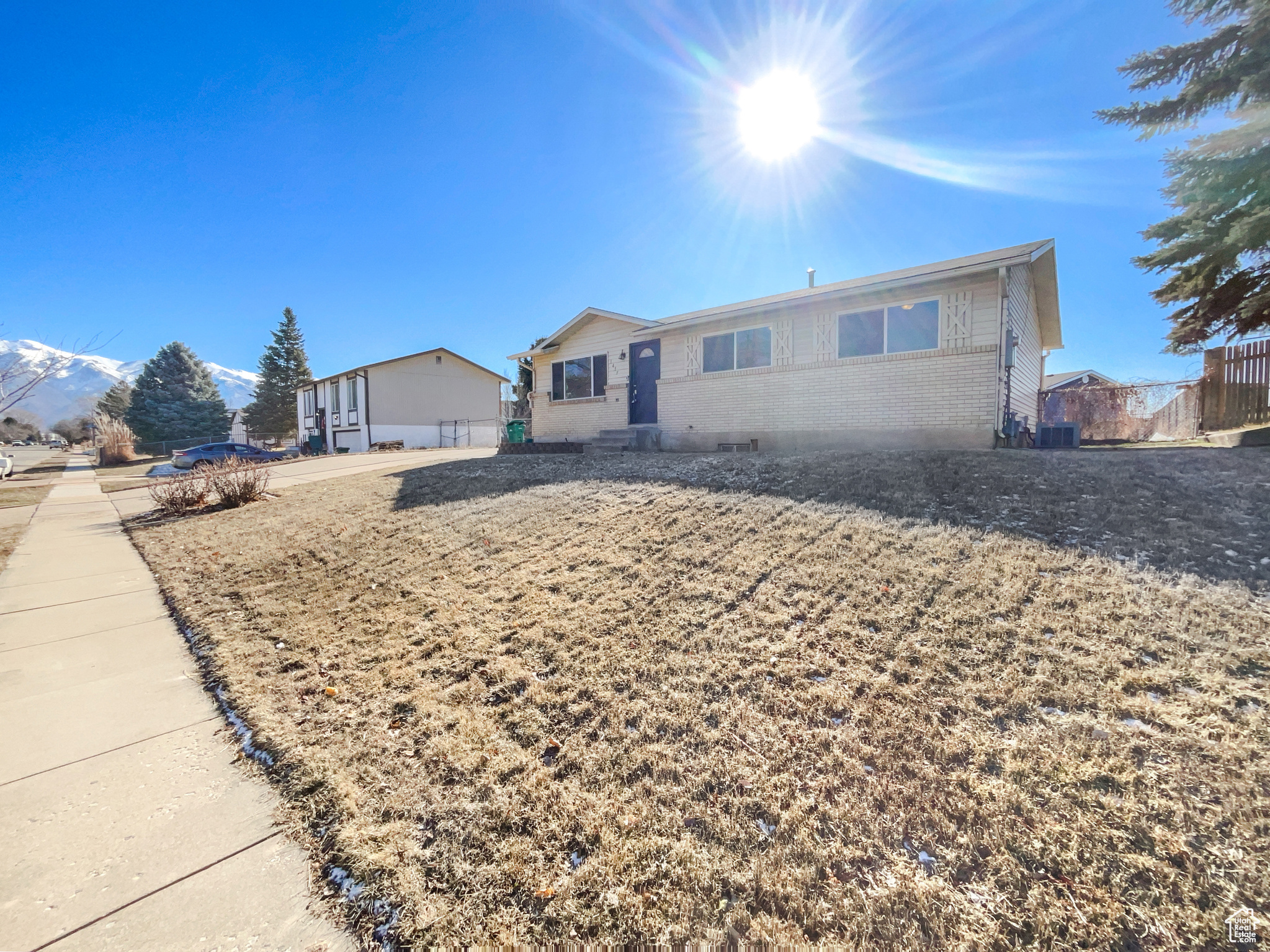 Single story home featuring fence and brick siding