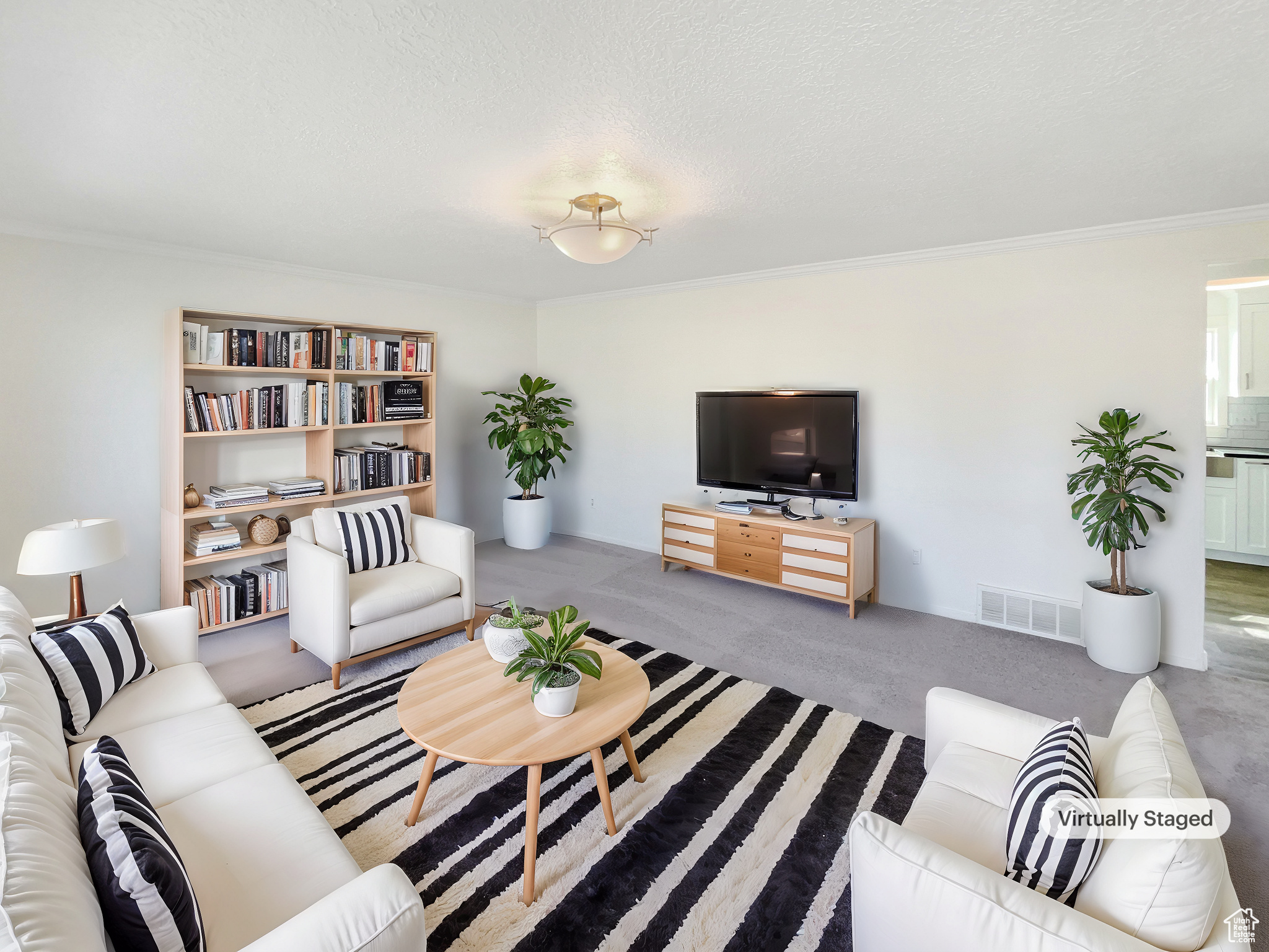 Living room with ornamental molding, visible vents, a textured ceiling, and carpet floors