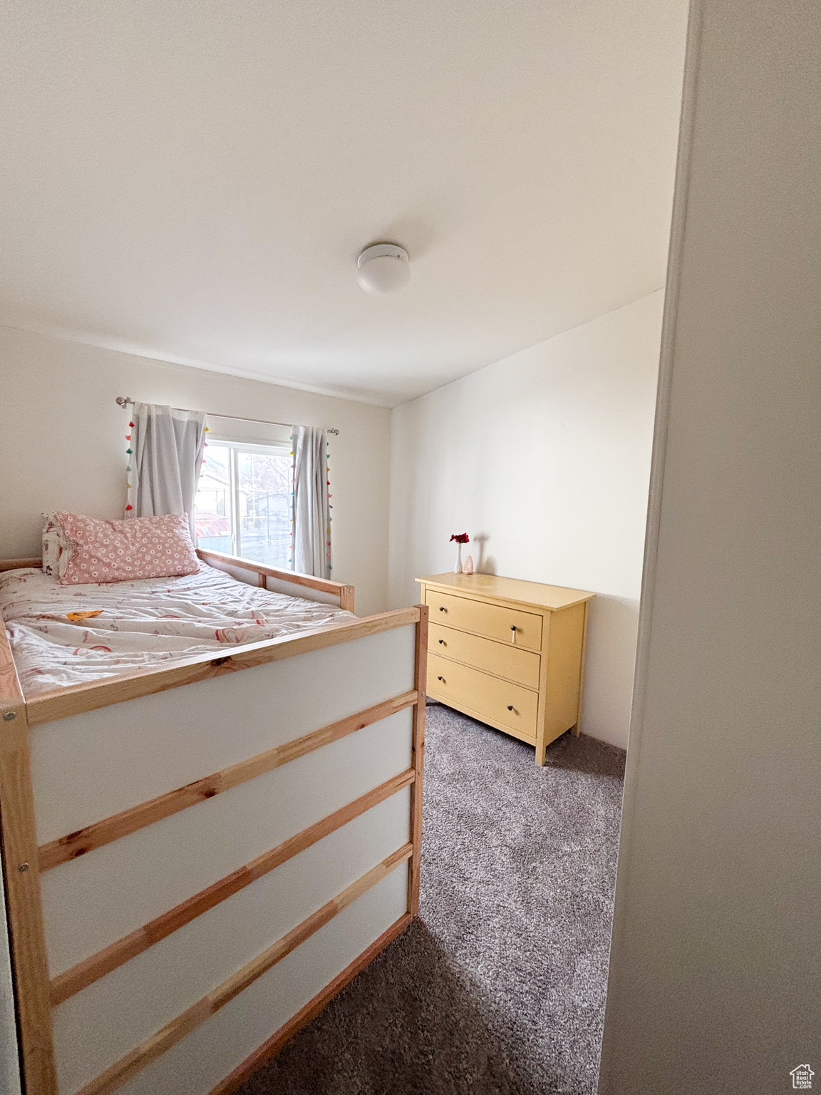 Bedroom with light colored carpet