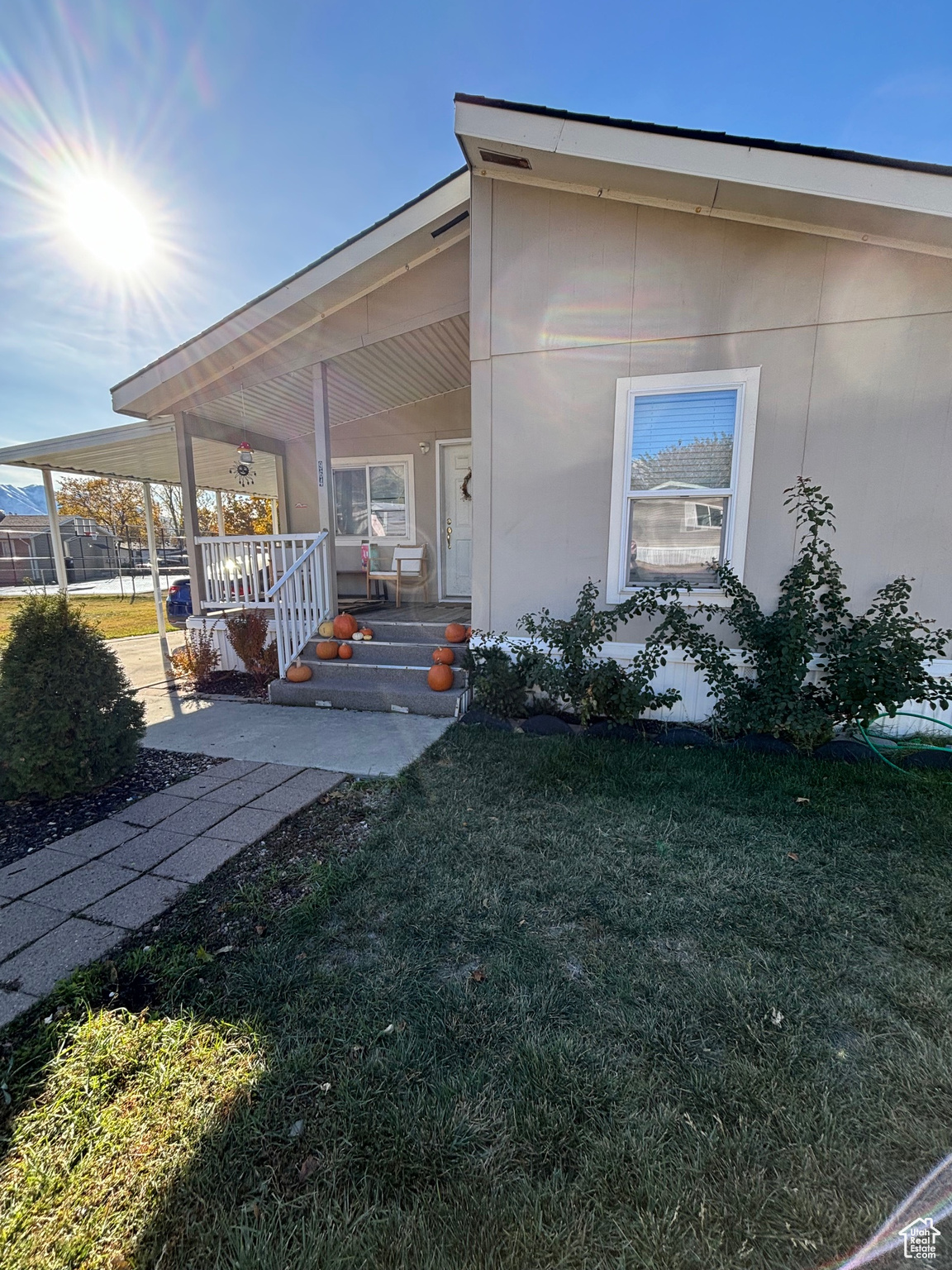 Exterior space featuring covered porch and a lawn