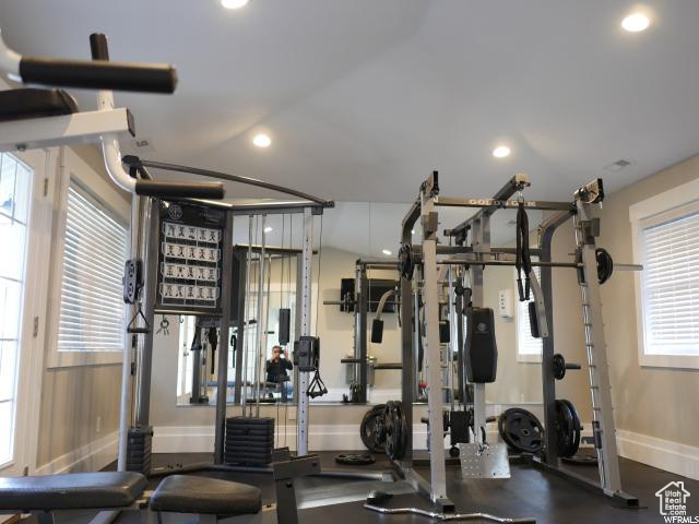 Gym with baseboards and recessed lighting