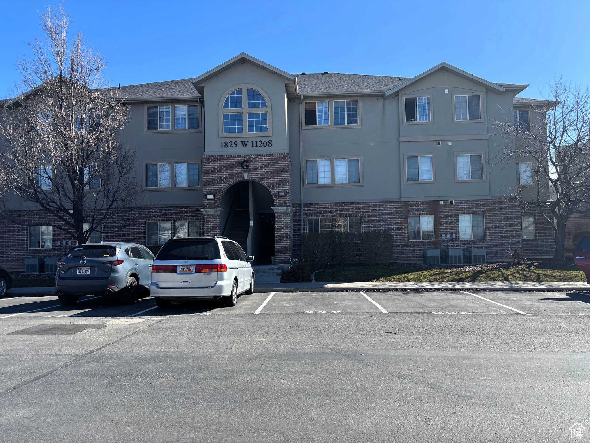 View of building exterior featuring uncovered parking