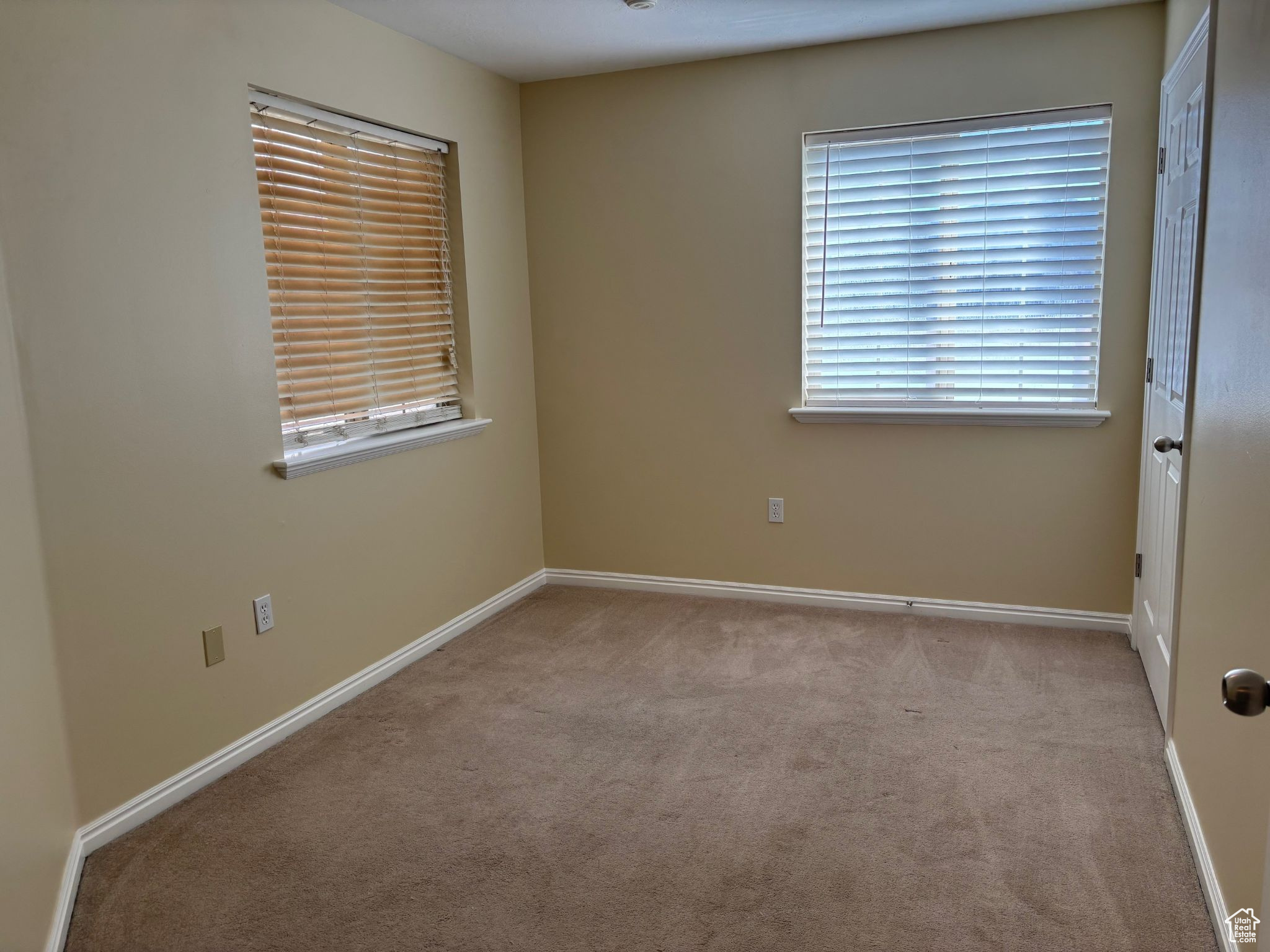 Bedroom  featuring light carpet and baseboards