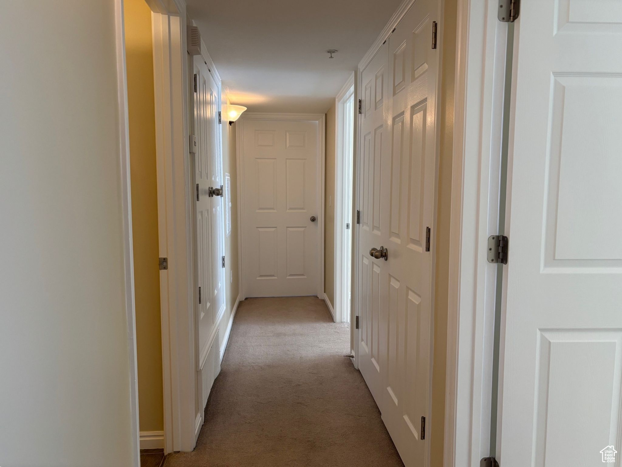 Hall with light colored carpet