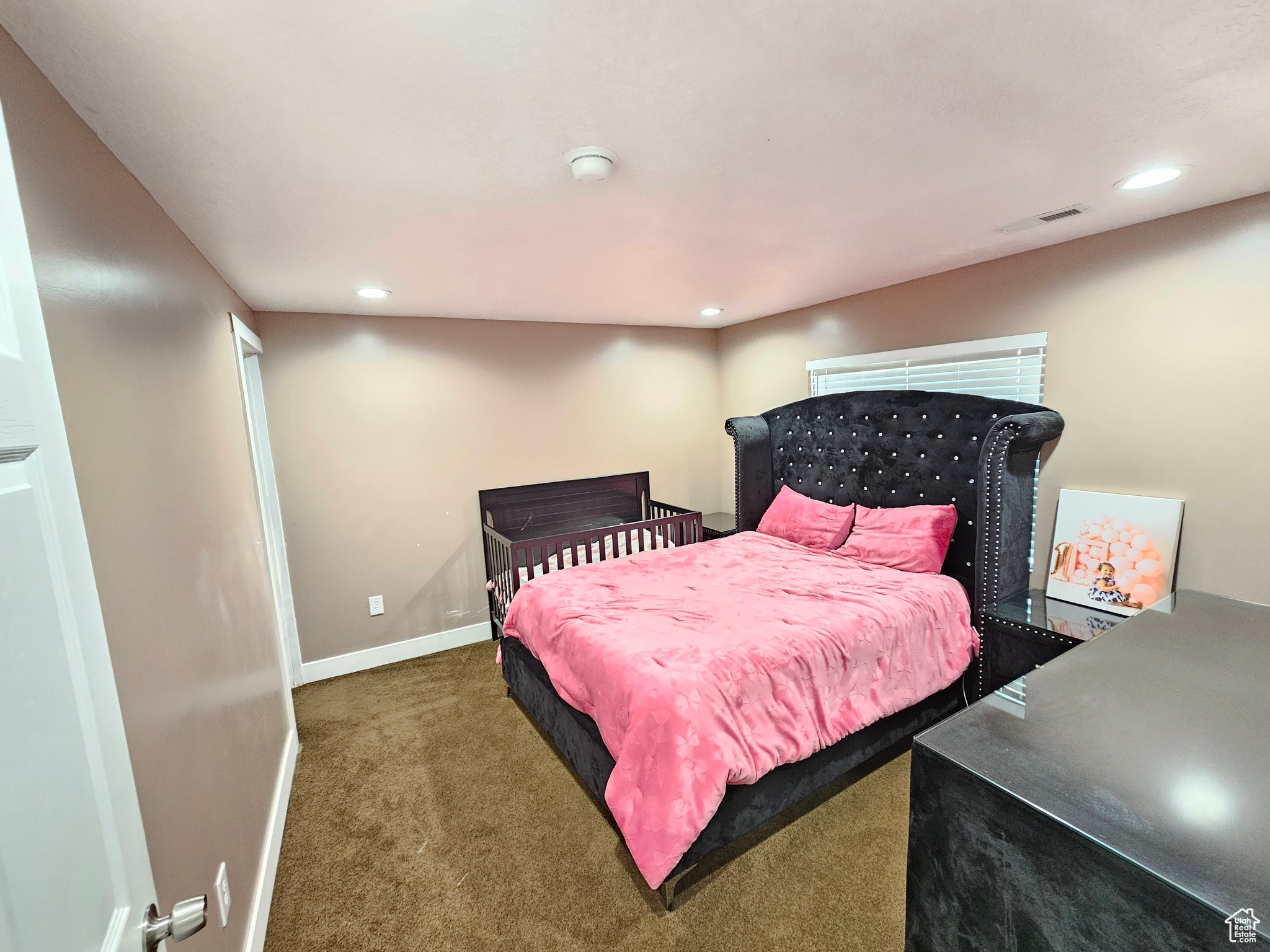 Bedroom featuring dark colored carpet, visible vents, baseboards, and recessed lighting