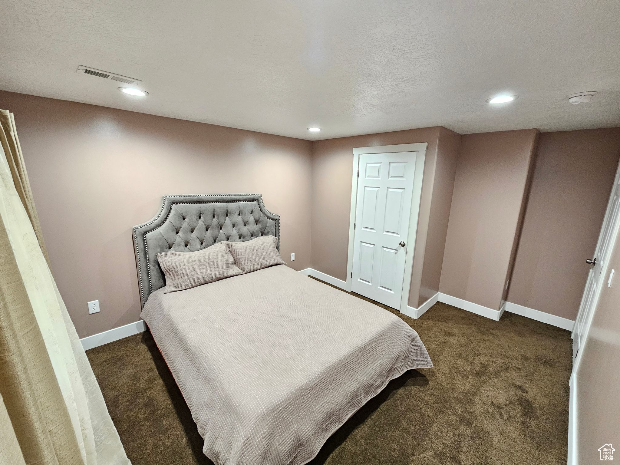 Bedroom with recessed lighting, visible vents, dark carpet, and baseboards