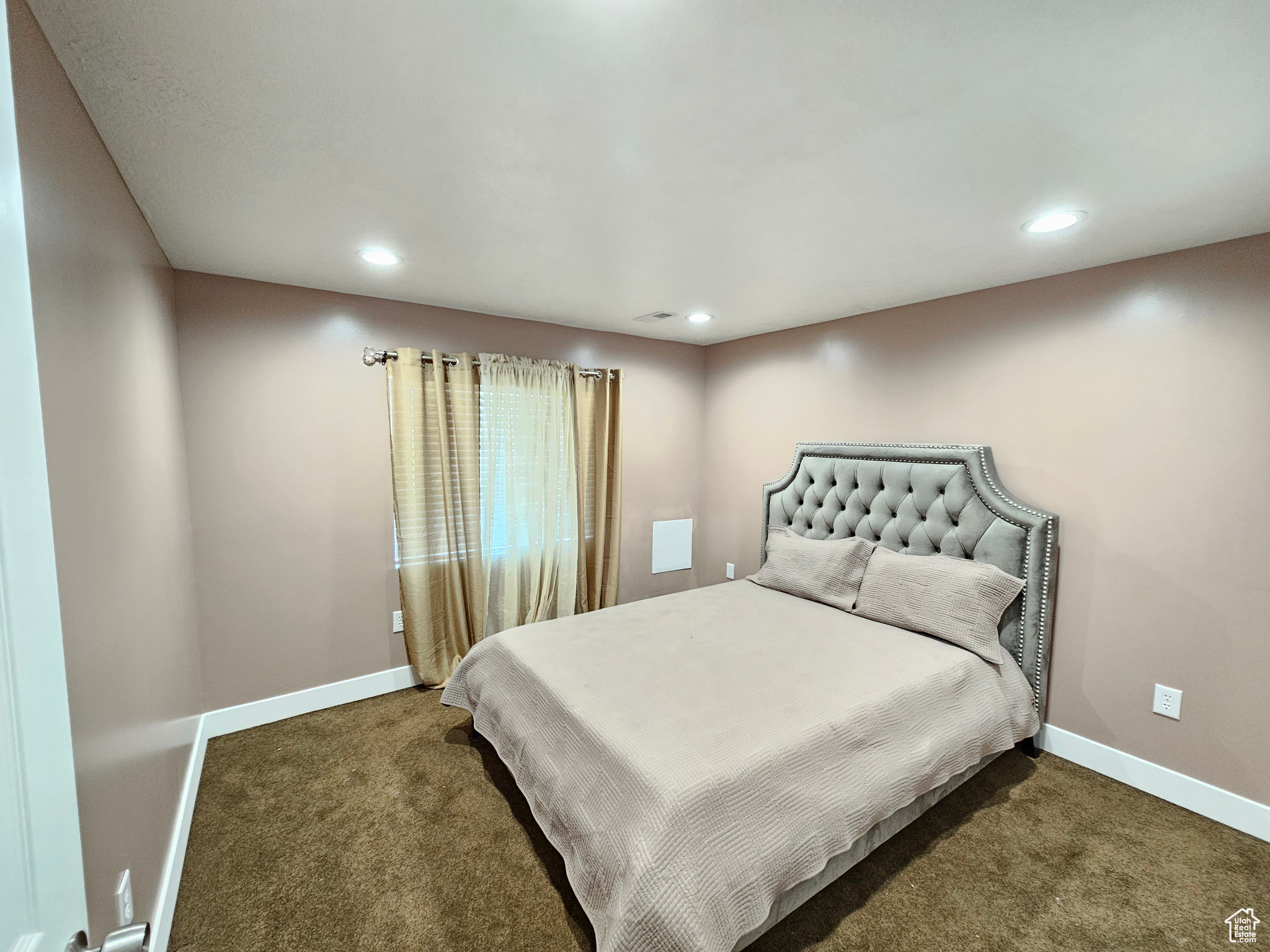 Bedroom featuring dark colored carpet, recessed lighting, and baseboards