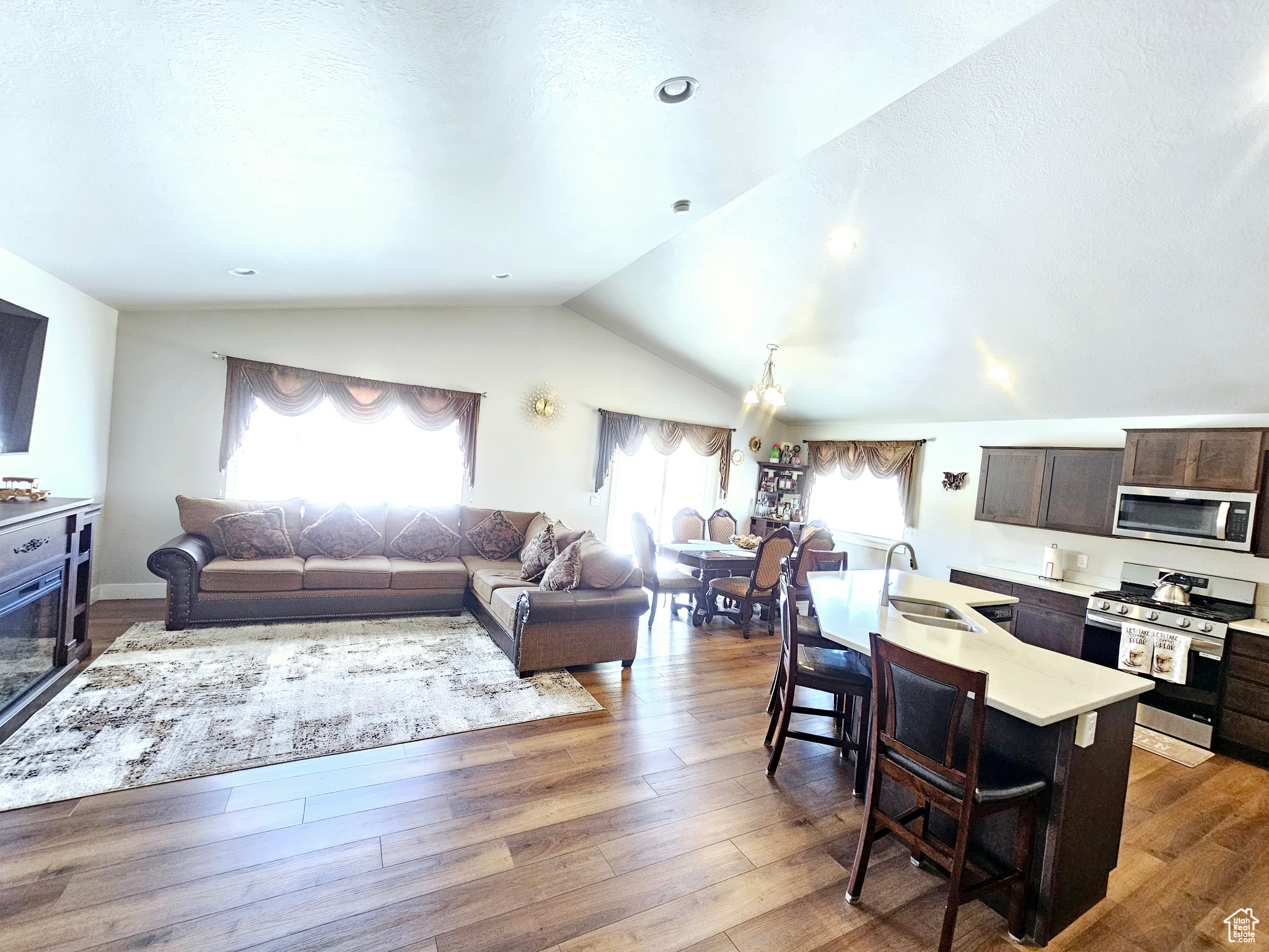 Living room with dark wood-style floors and vaulted ceiling