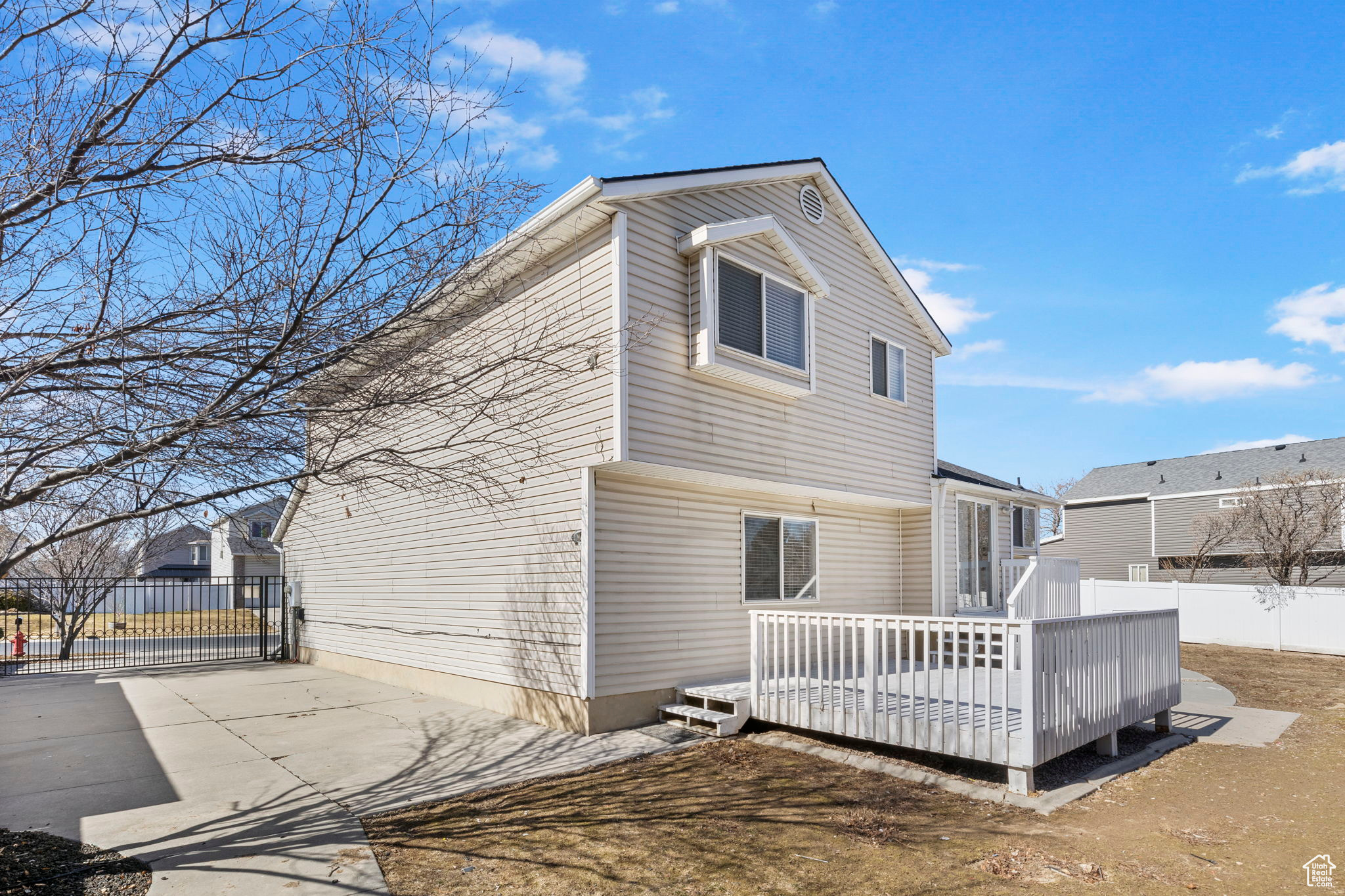 View of front facade featuring a deck and fence