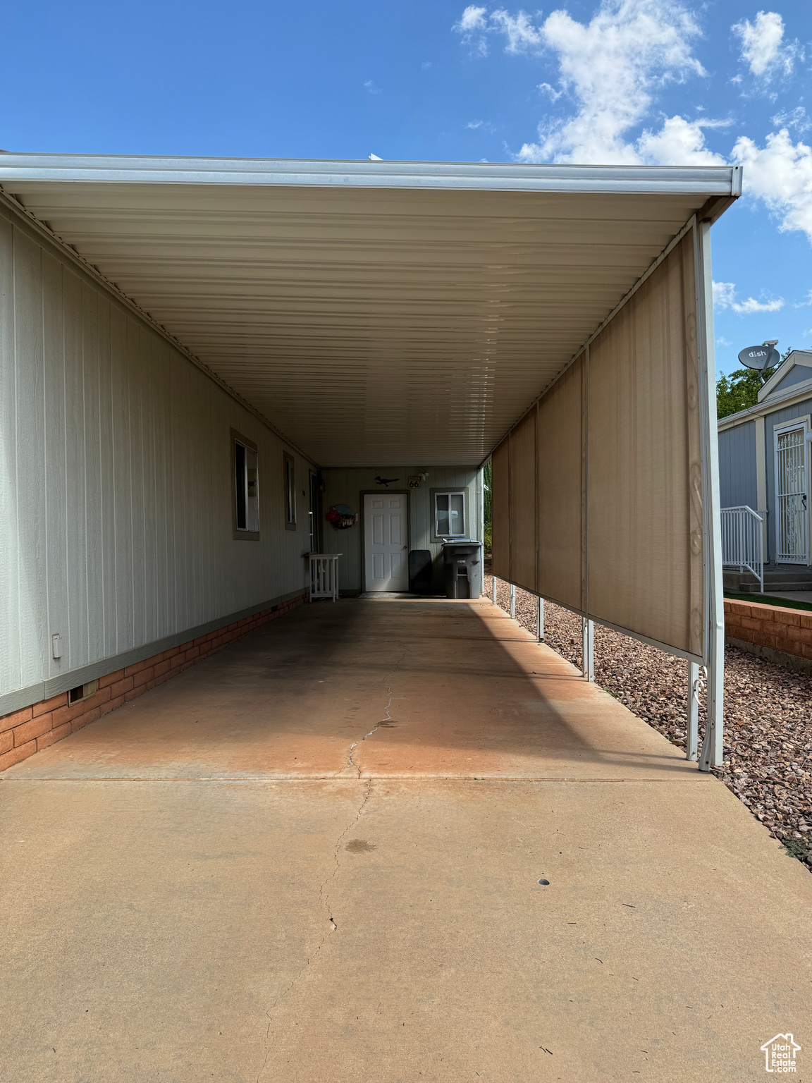 View of car parking with driveway and an attached carport