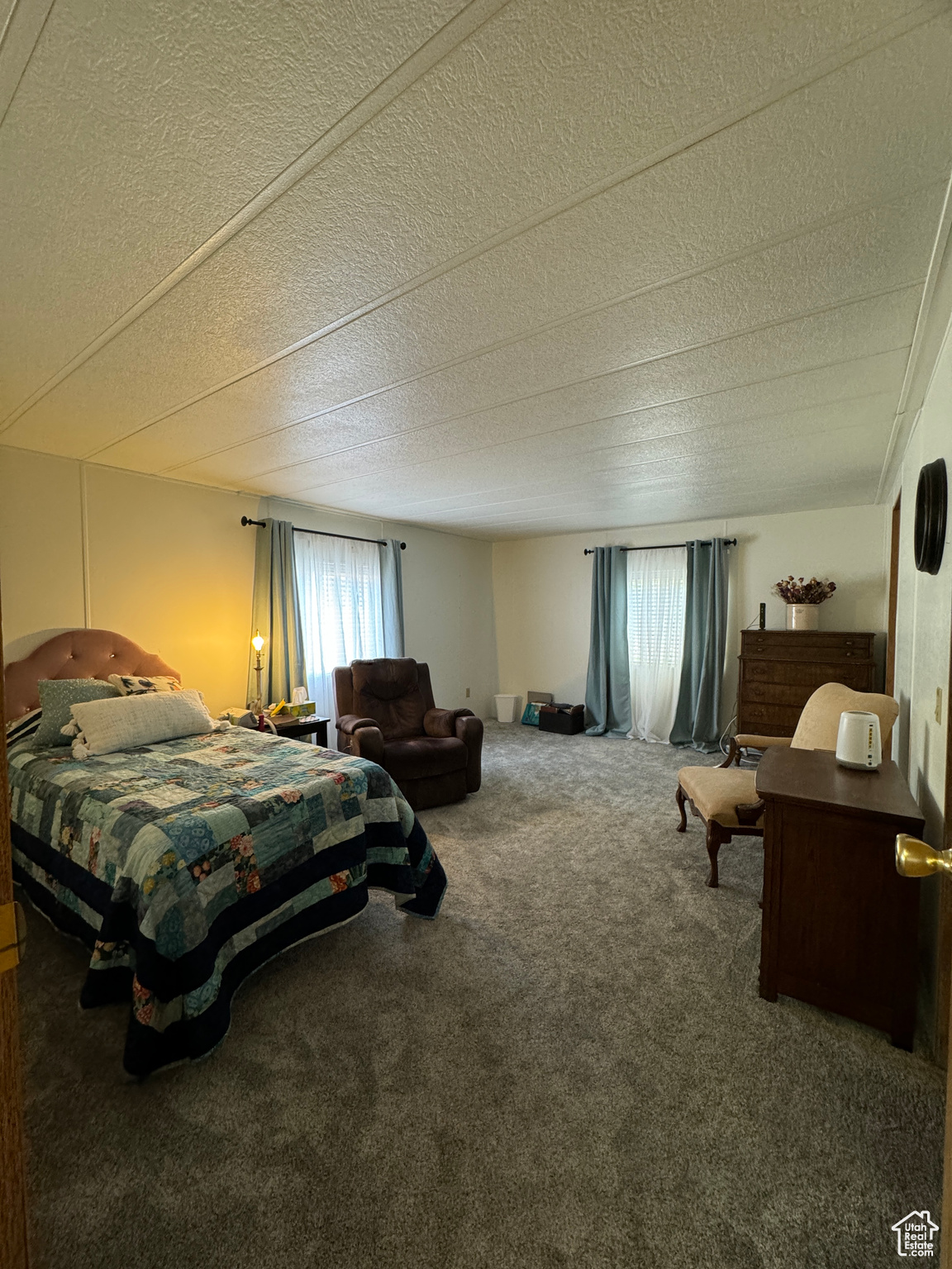Bedroom with carpet and a textured ceiling