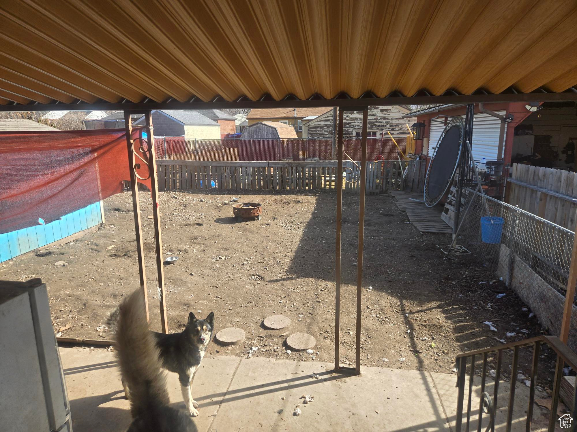 View of yard with an outdoor fire pit and a fenced backyard