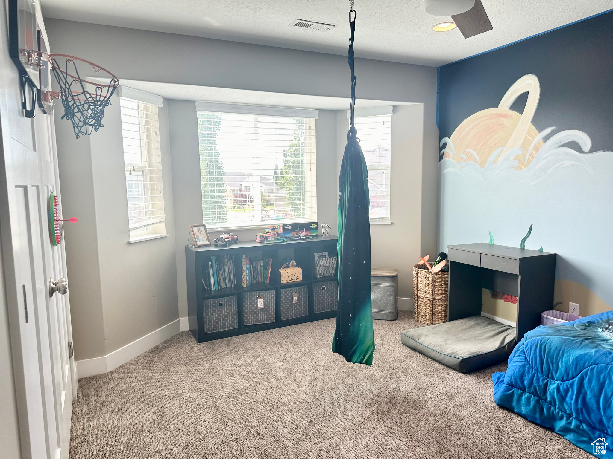 Carpeted bedroom with baseboards, visible vents, and a textured ceiling