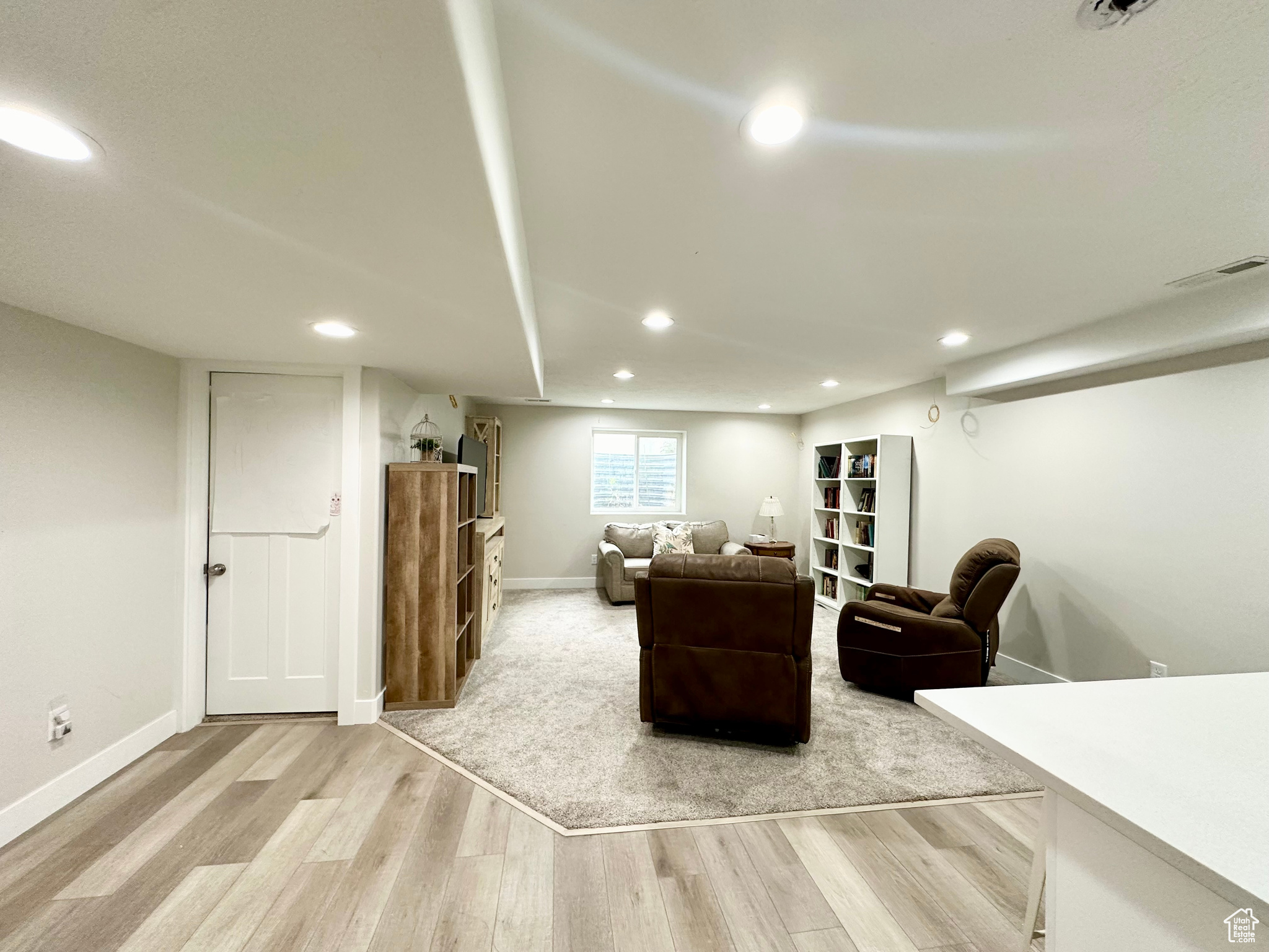 Living room with baseboards, wood finished floors, visible vents, and recessed lighting