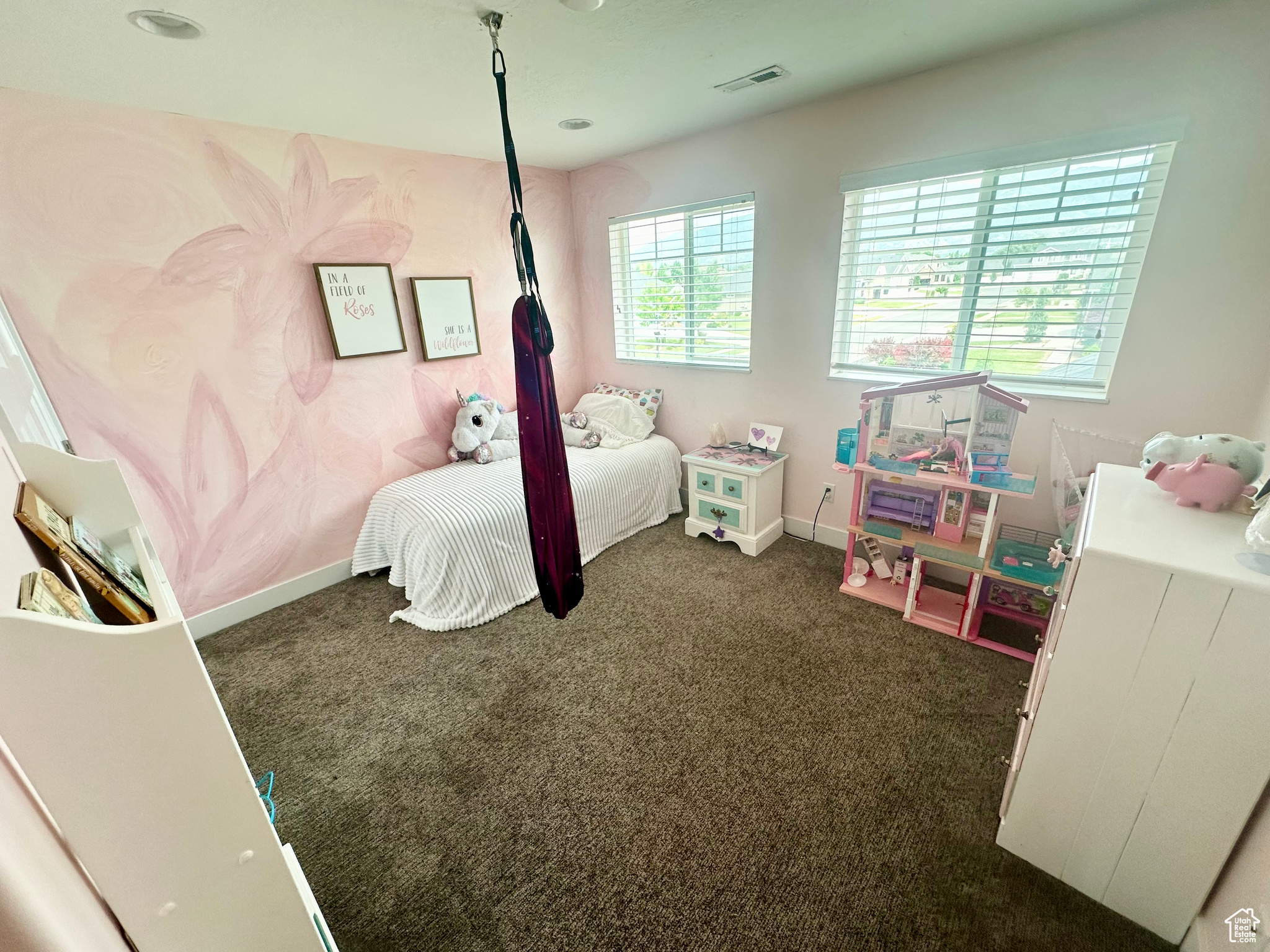 Bedroom featuring baseboards, visible vents, and dark carpet