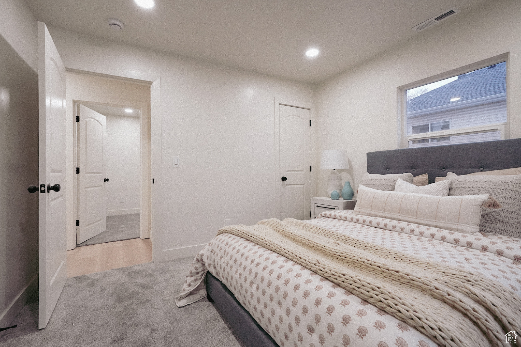 Bedroom with light carpet, baseboards, visible vents, and recessed lighting