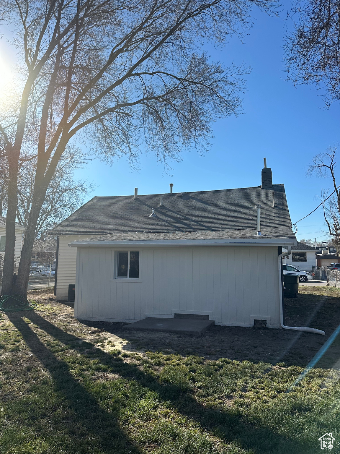 View of property exterior featuring a yard and a chimney