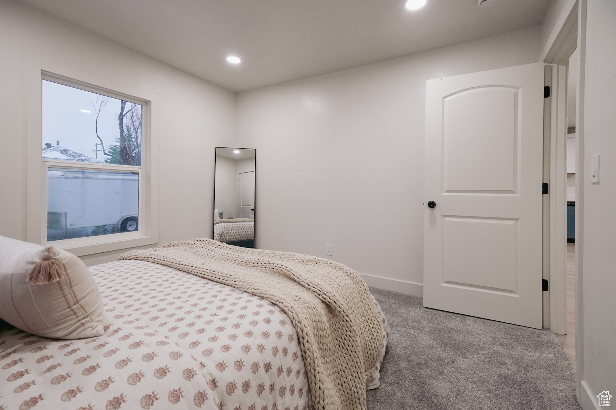 Carpeted bedroom with baseboards and recessed lighting