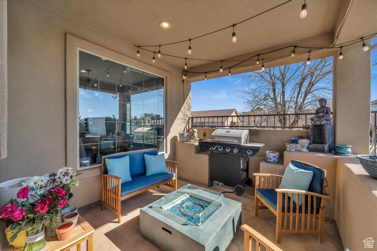 View of patio / terrace featuring an outdoor living space with a fire pit and area for grilling