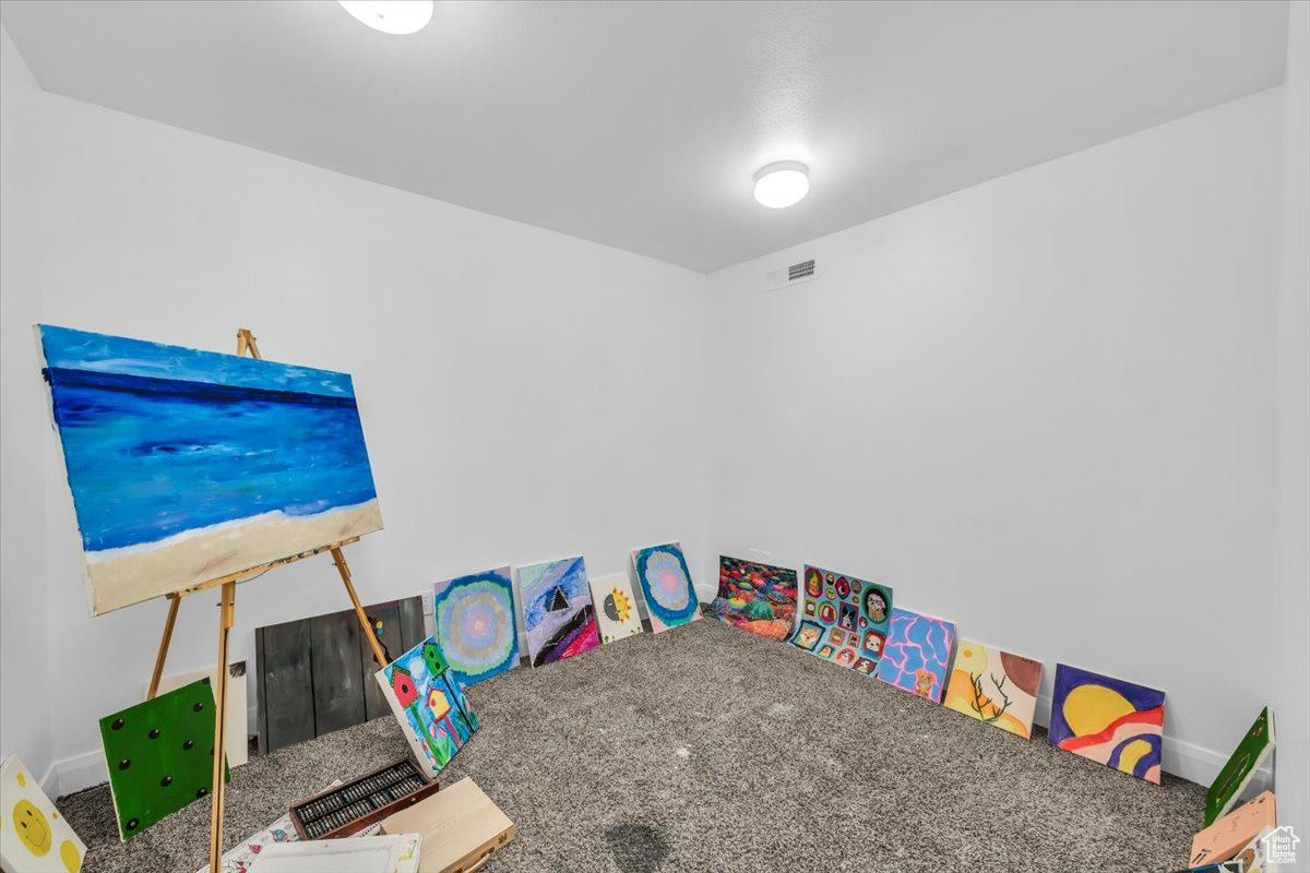 Recreation room with carpet floors and visible vents