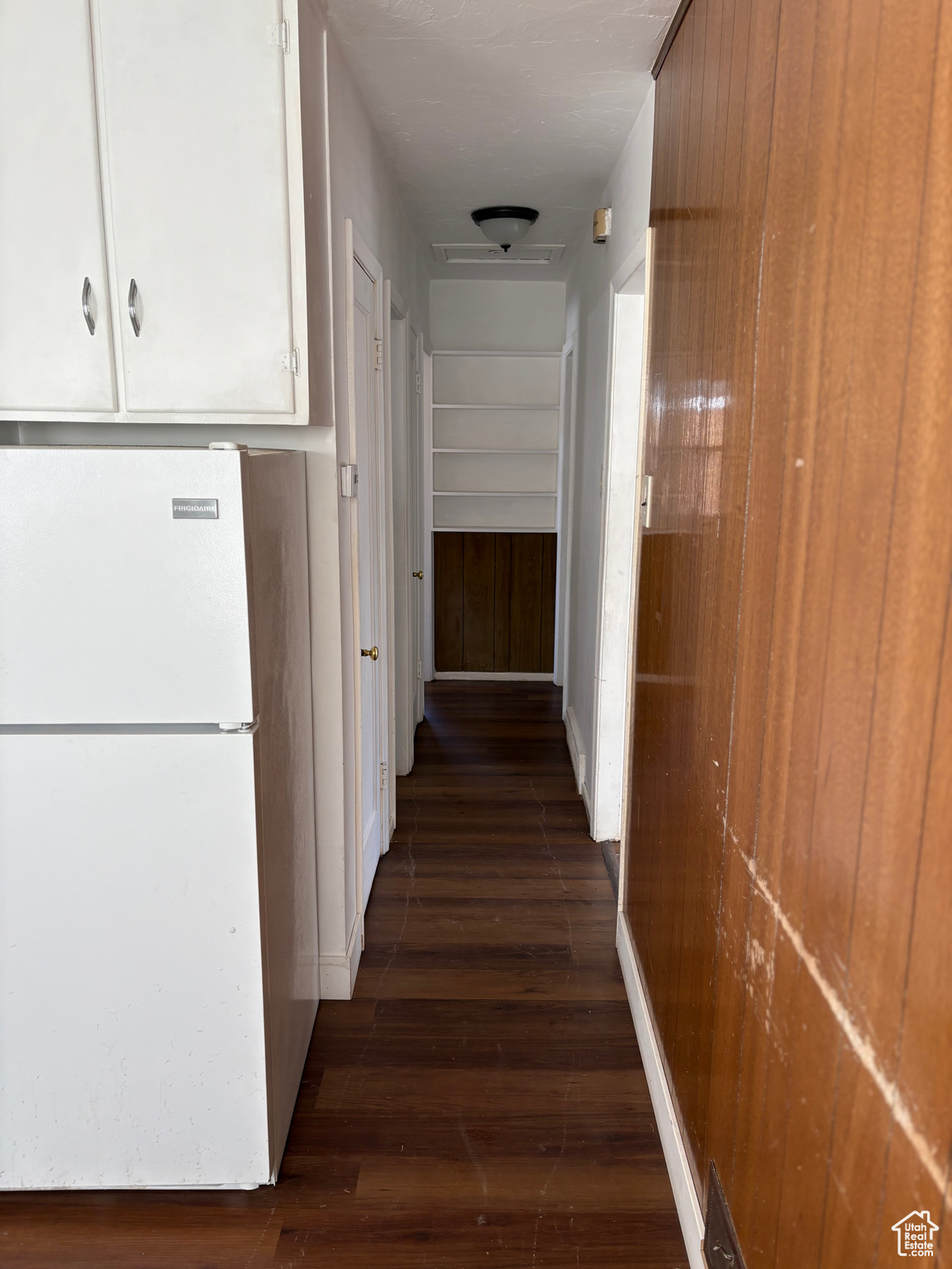 Hallway featuring dark wood finished floors