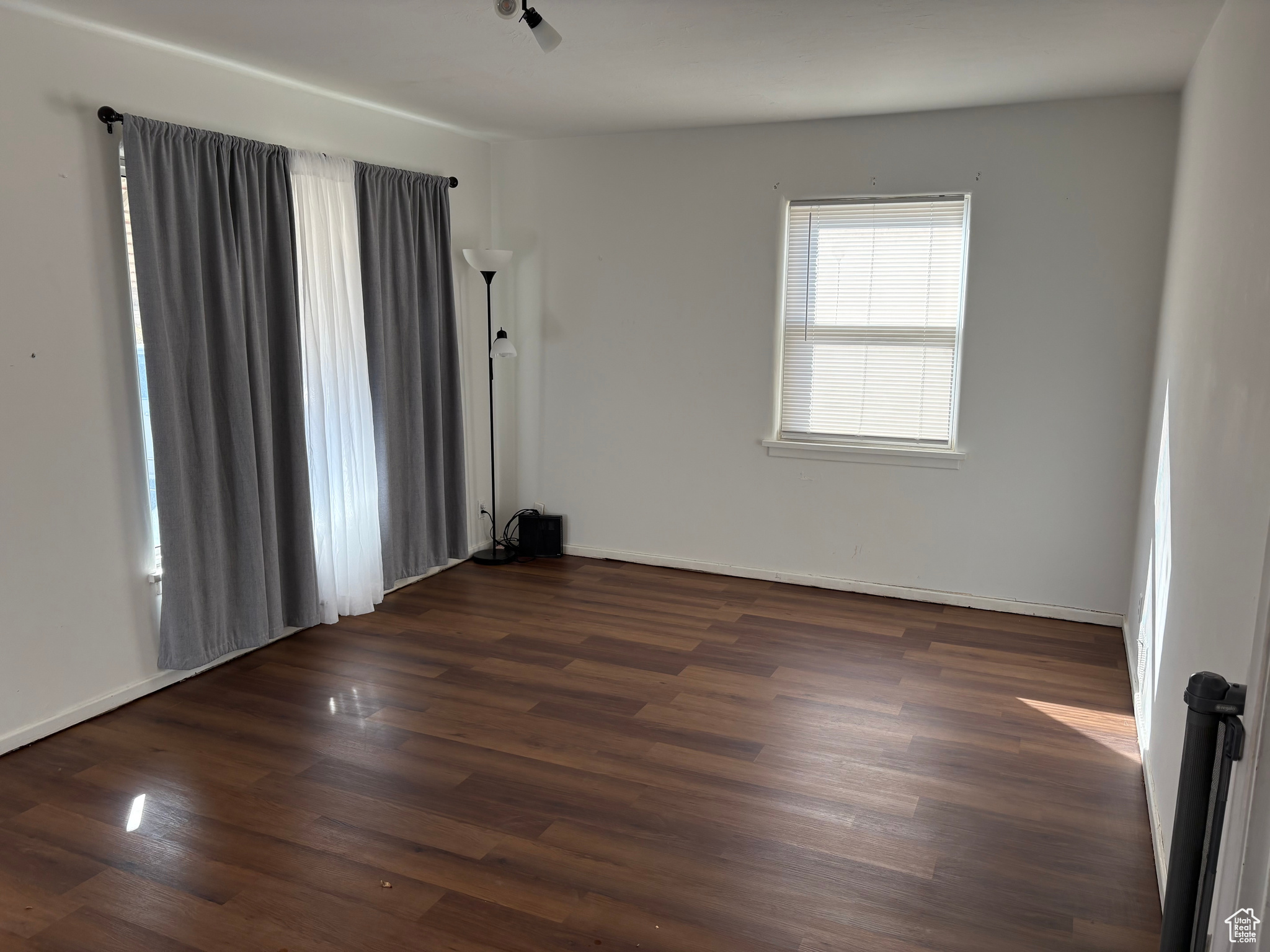 Empty room with dark wood finished floors