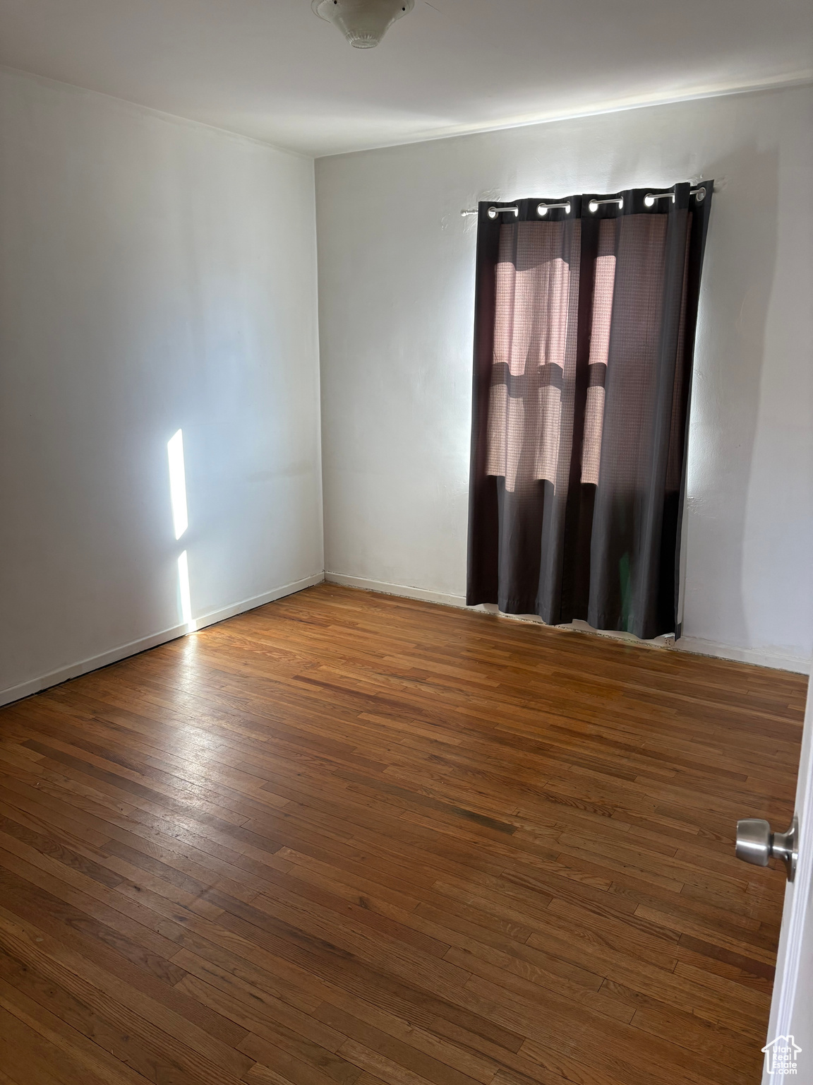 Unfurnished bedroom featuring dark wood-style flooring