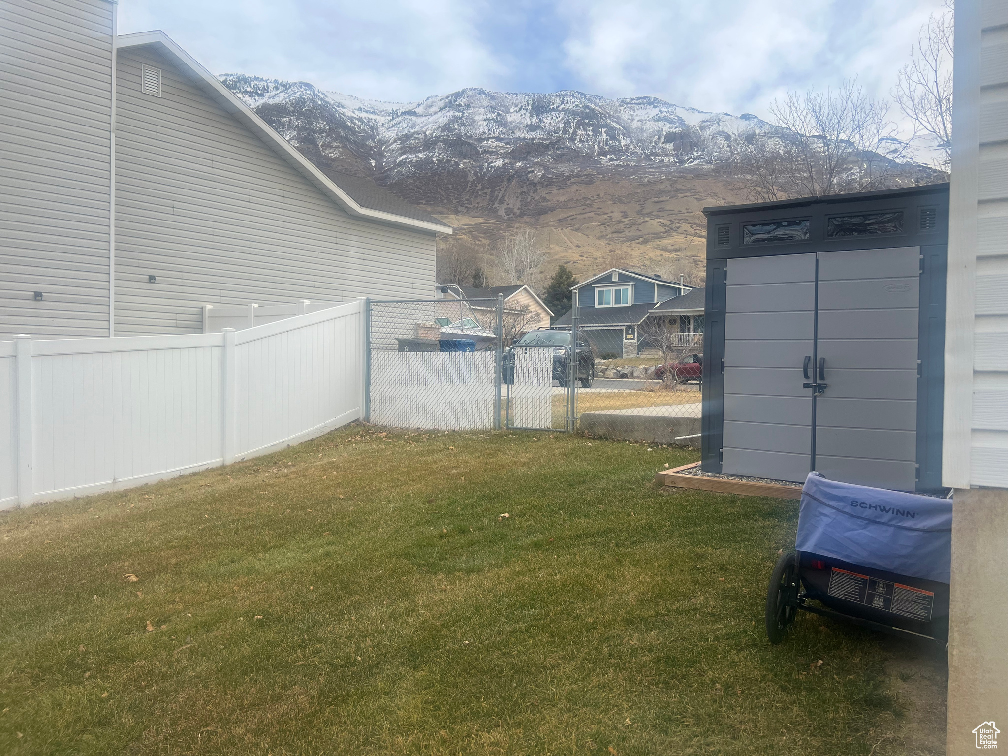 View of yard with fence and a mountain view