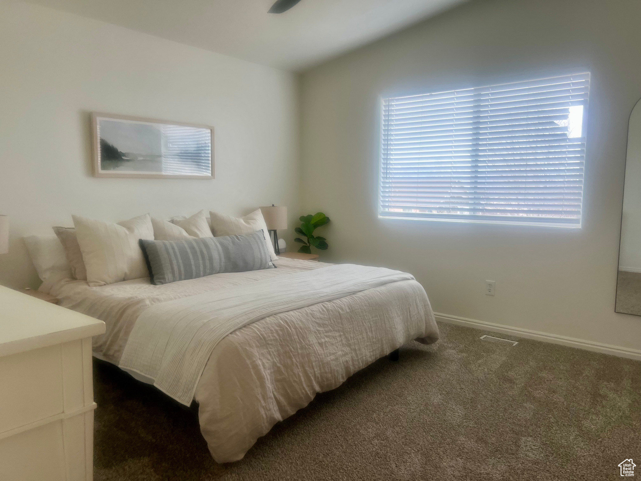 Bedroom featuring dark colored carpet, lofted ceiling, and baseboards