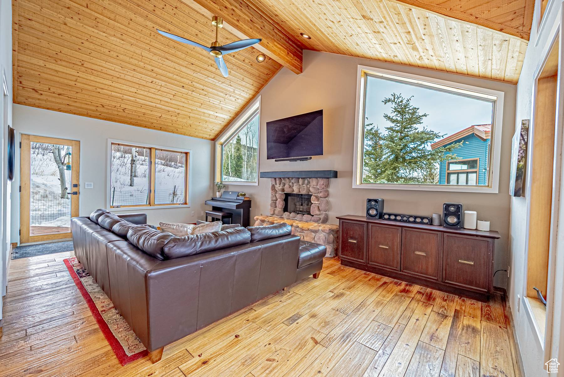 Living area featuring lofted ceiling with beams, wooden ceiling, and light wood-style floors