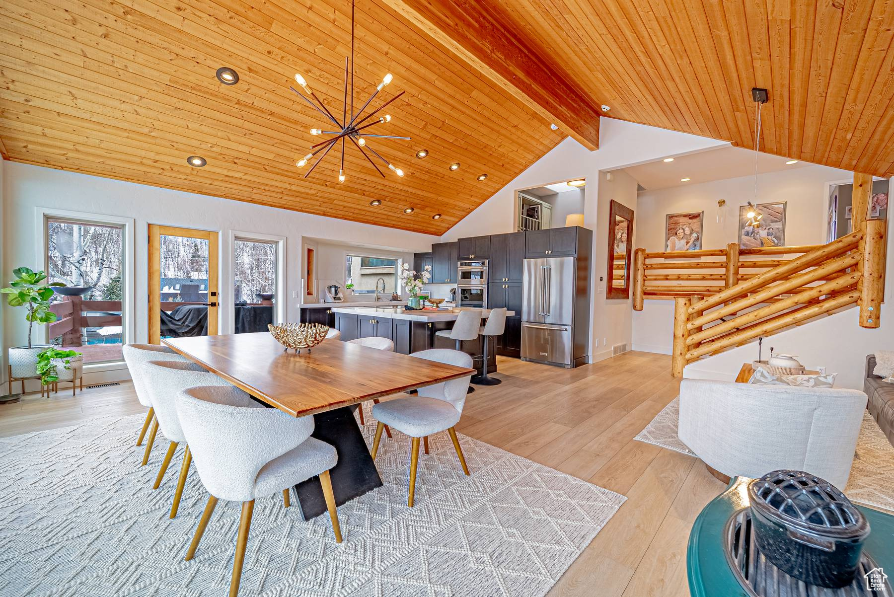 Dining space with a chandelier, recessed lighting, wood ceiling, light wood finished floors, and beamed ceiling