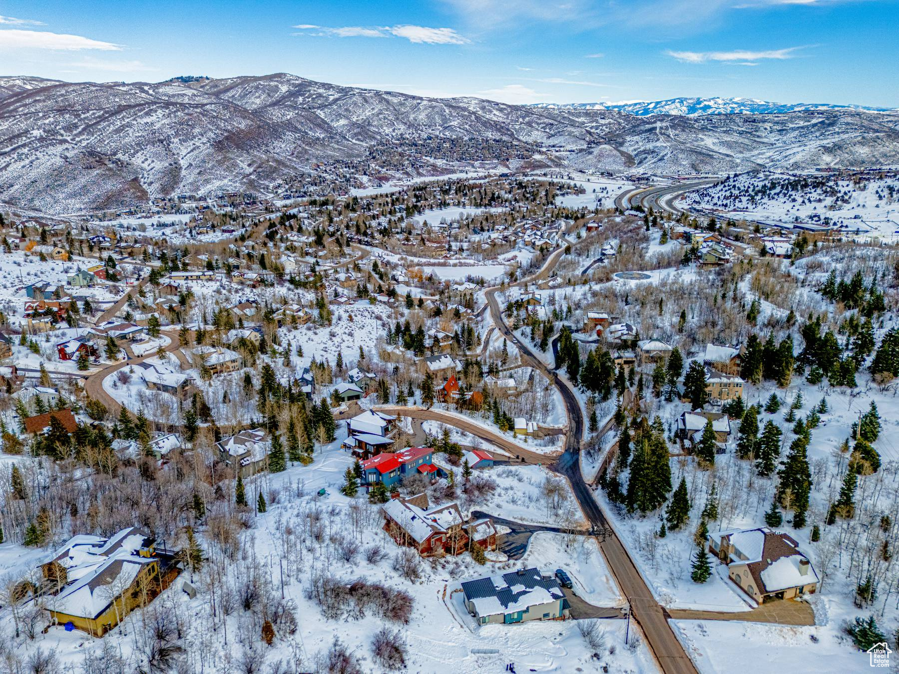Snowy aerial view featuring a residential view and a mountain view