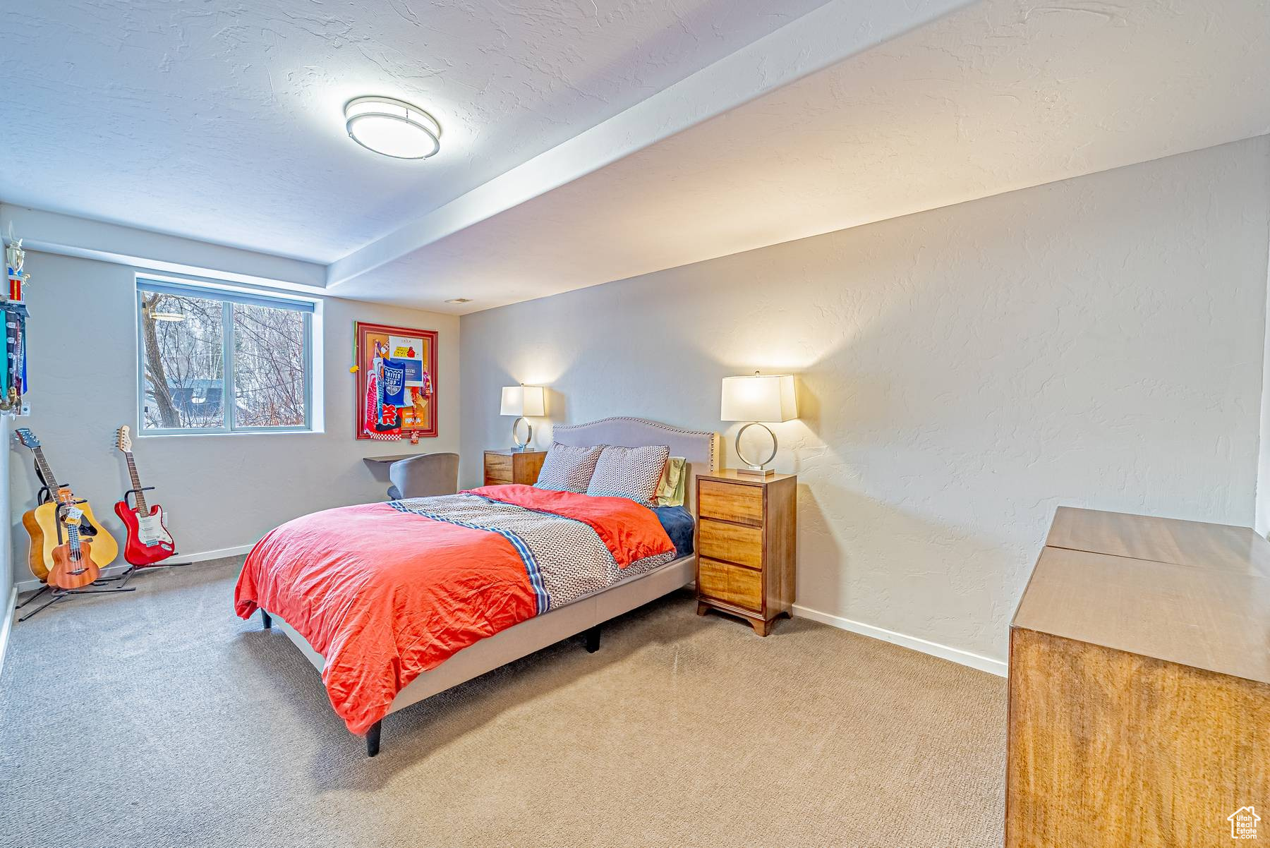 Carpeted bedroom with baseboards, a textured ceiling, and a textured wall